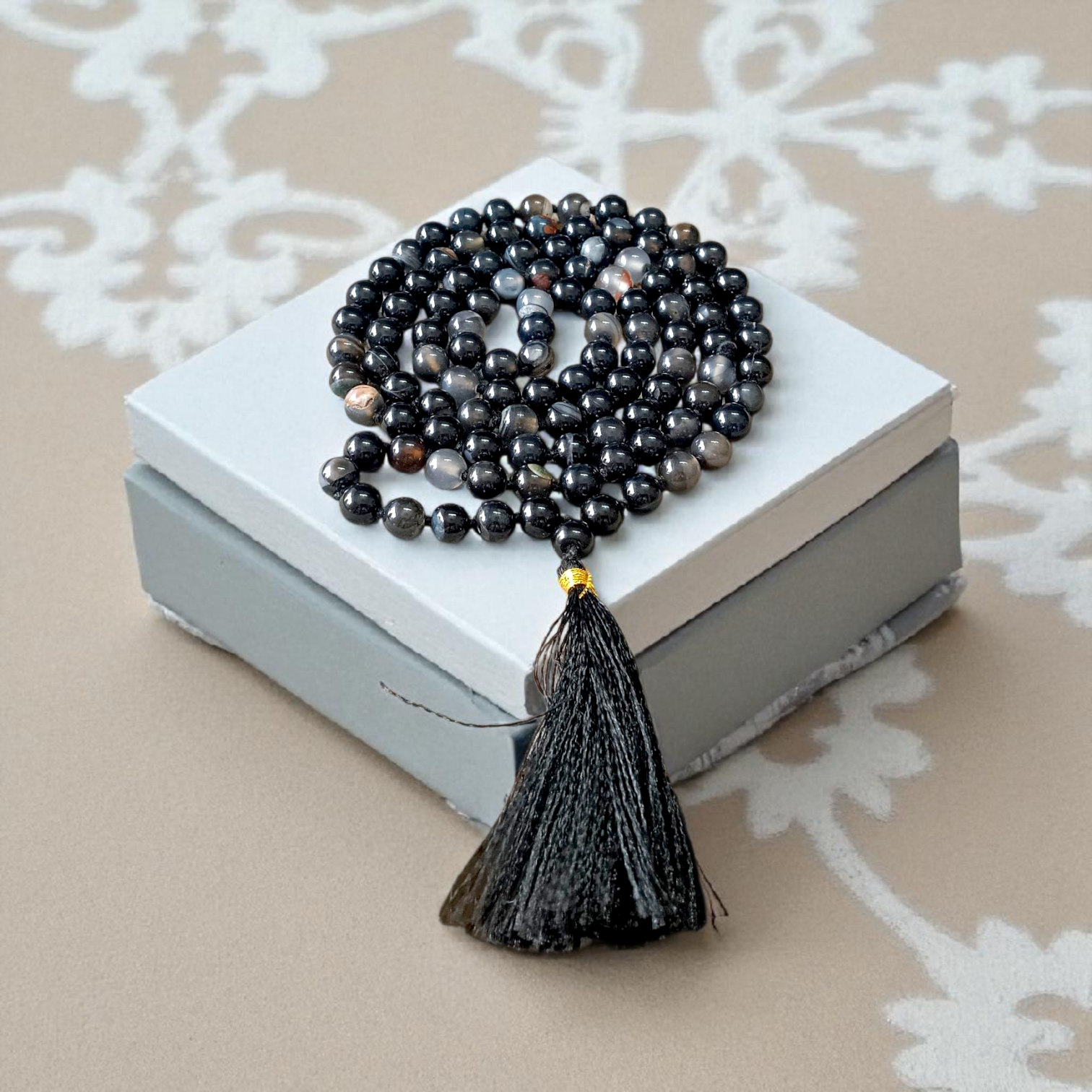 Image of Natural Sulemani Hakik Mala (Black Agate) with 8MM smooth round beads, available in 108+1 and 27+1 configurations, used for meditation and daily wear