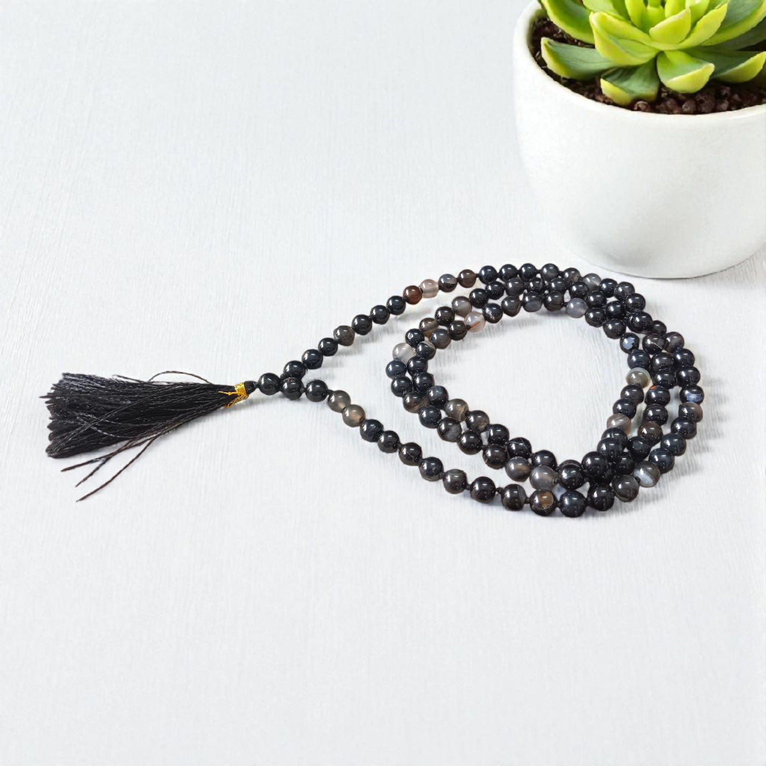 Image of Natural Sulemani Hakik Mala (Black Agate) with 8MM smooth round beads, available in 108+1 and 27+1 configurations, used for meditation and daily wear