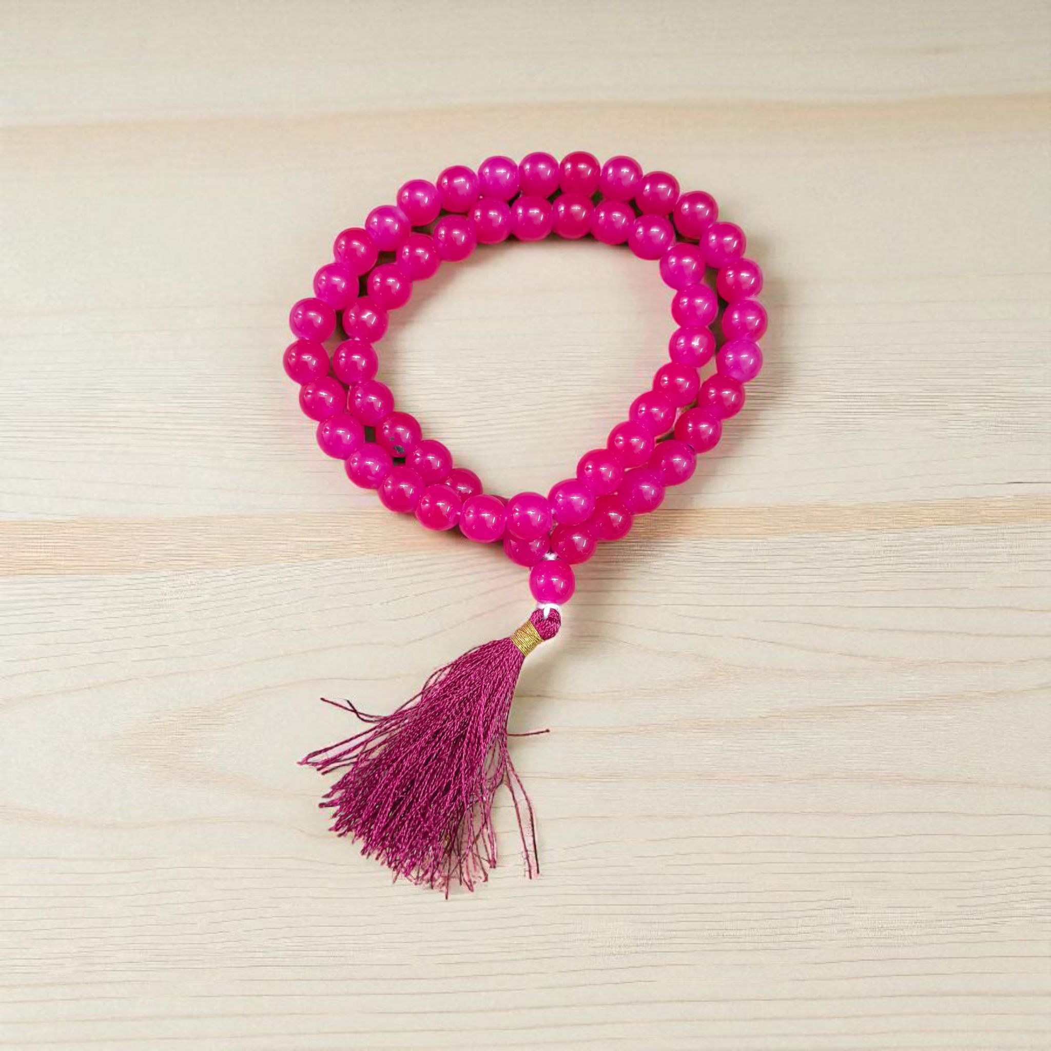Image of Pink Agate Mala with 54+1 polished 8mm pink beads, ideal for mantra chanting, emotional healing, and meditation, displayed on a neutral background