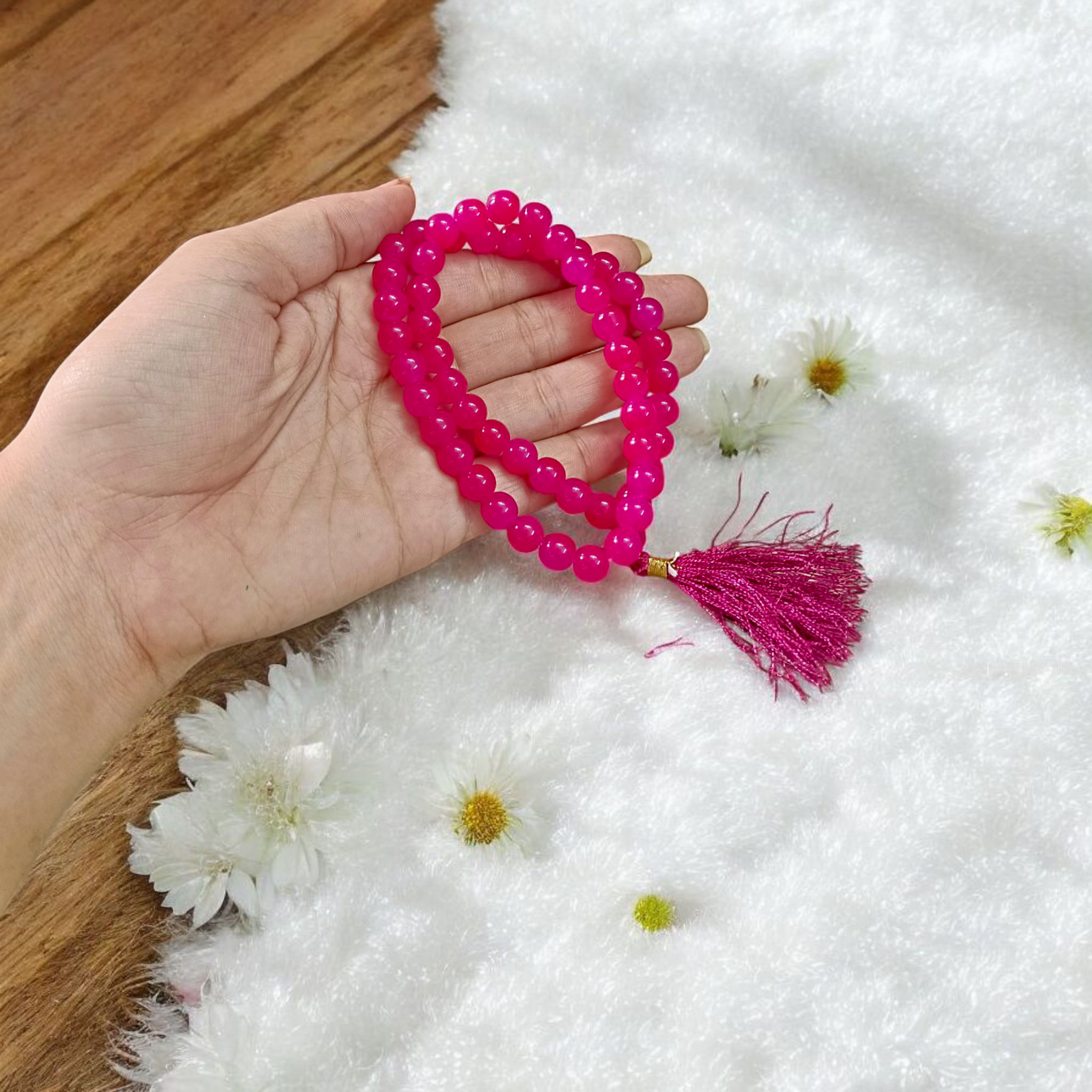 Image of Pink Agate Mala with 54+1 polished 8mm pink beads, ideal for mantra chanting, emotional healing, and meditation, displayed on a neutral background