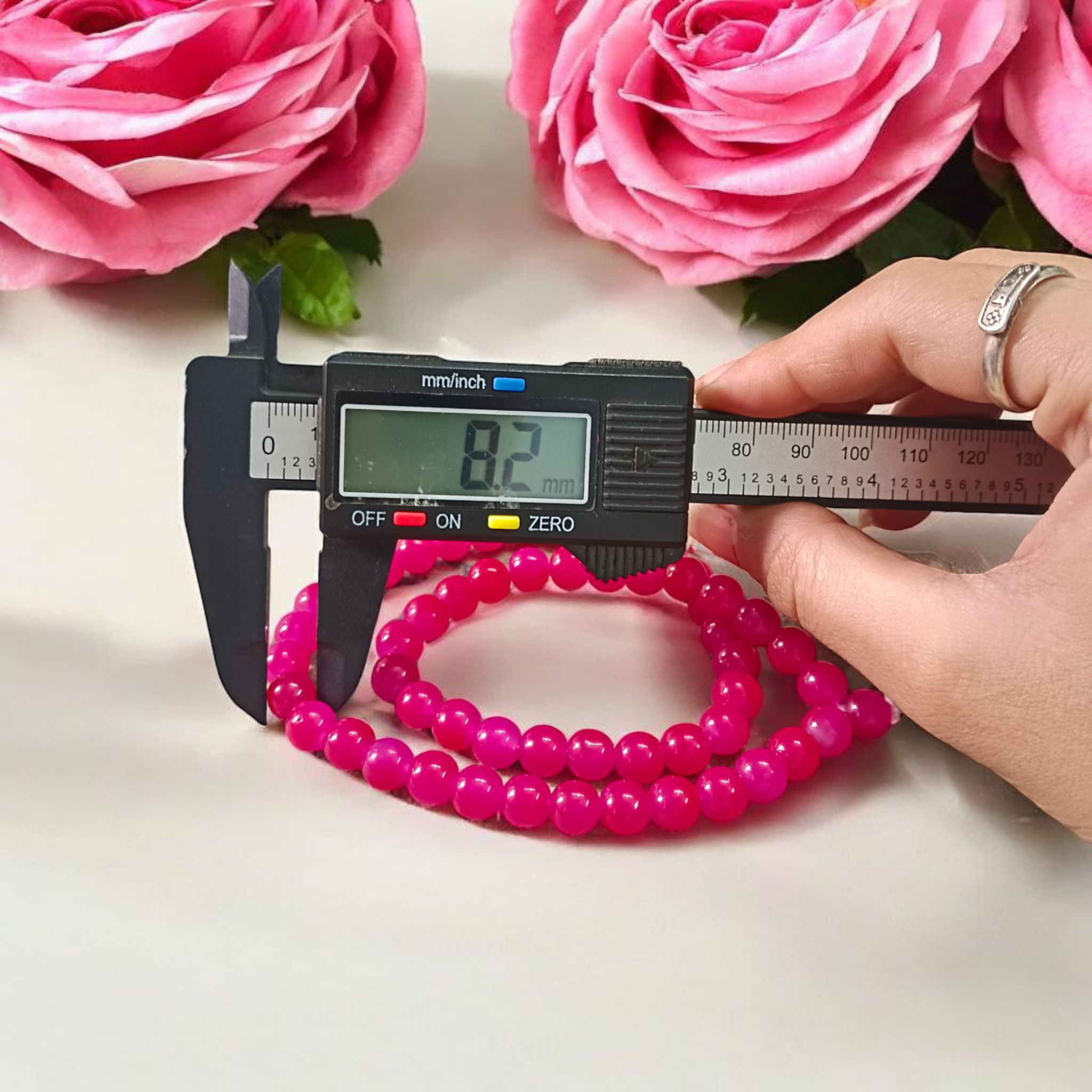 Image of Pink Agate Mala with 54+1 polished 8mm pink beads, ideal for mantra chanting, emotional healing, and meditation, displayed on a neutral background