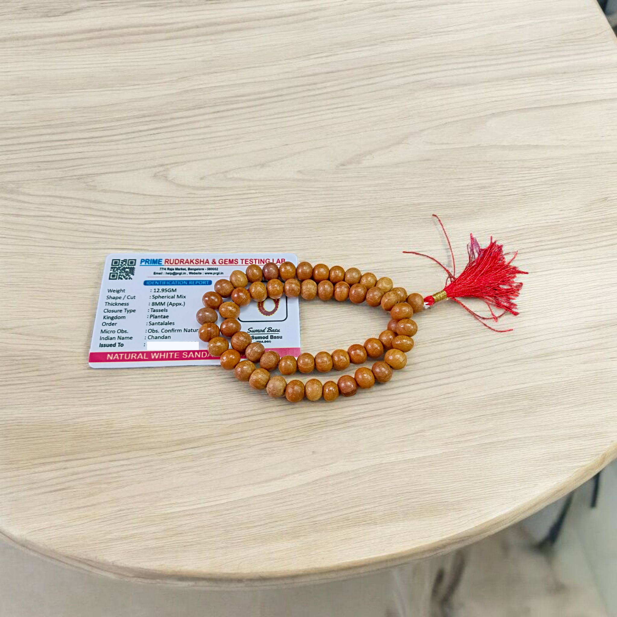 Image of Safed Chandan Mala with 54+1 smooth 8mm white sandalwood beads, naturally fragrant, arranged for meditation, chanting, and spiritual peace