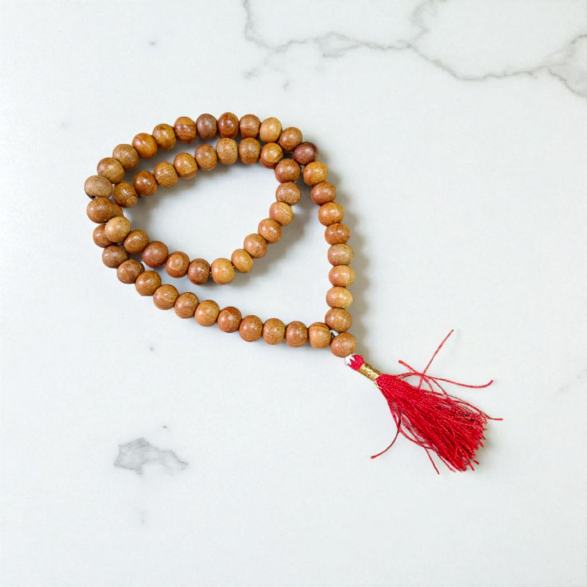 Image of Safed Chandan Mala with 54+1 smooth 8mm white sandalwood beads, naturally fragrant, arranged for meditation, chanting, and spiritual peace