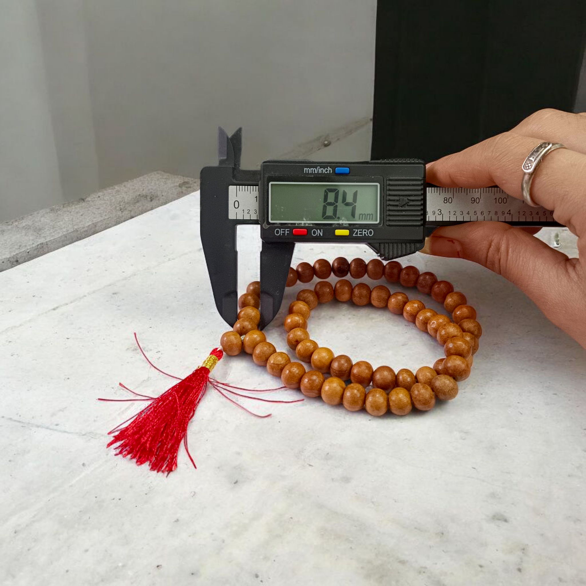 Image of Safed Chandan Mala with 54+1 smooth 8mm white sandalwood beads, naturally fragrant, arranged for meditation, chanting, and spiritual peace