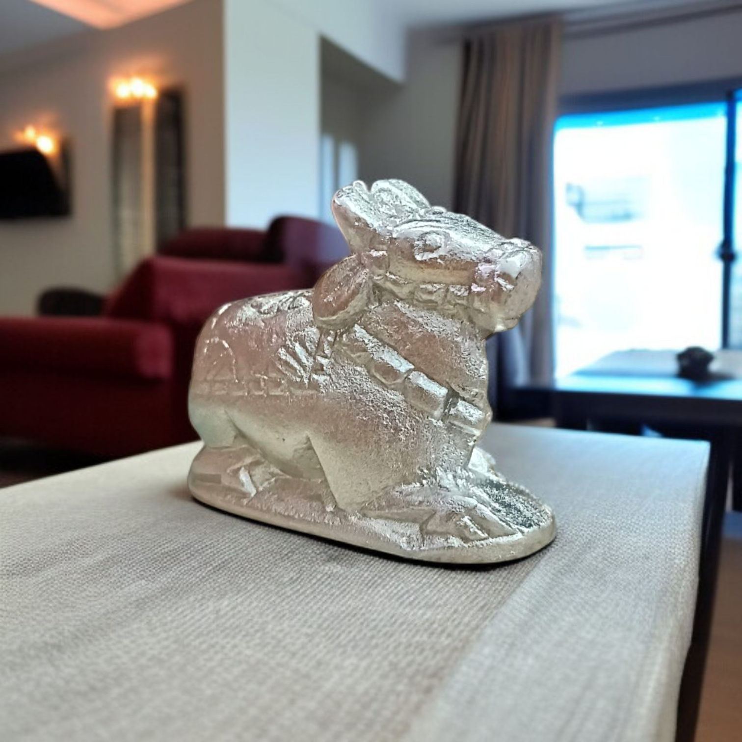 Image of a Natural Parad Nandi Idol made from mercury alloy, placed on a clean surface, reflecting divine and traditional craftsmanship