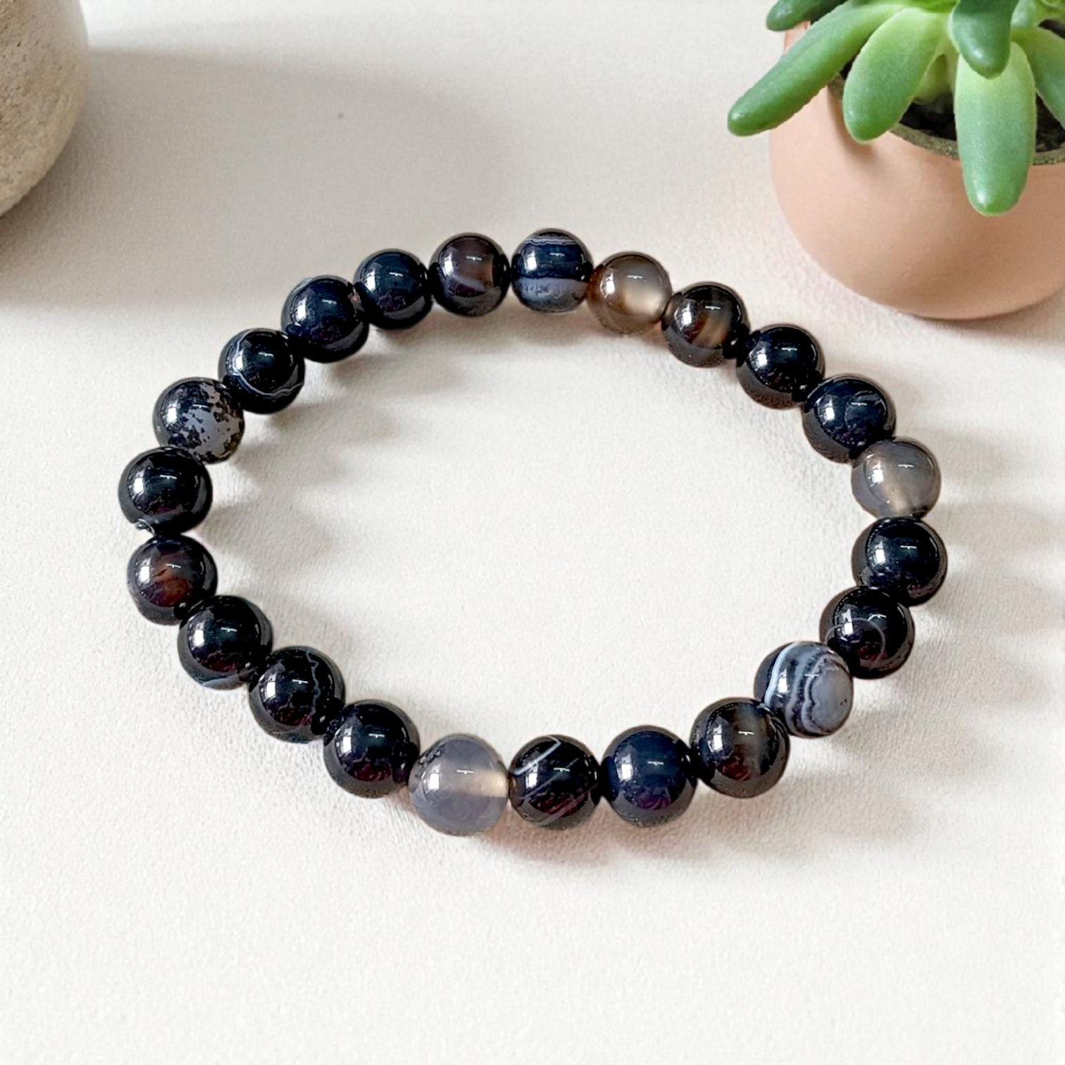 Image of a Natural Sulemani Hakik Bracelet with 8MM round Black Agate beads, stretchable to fit most wrists, designed for healing, protection, and daily wear