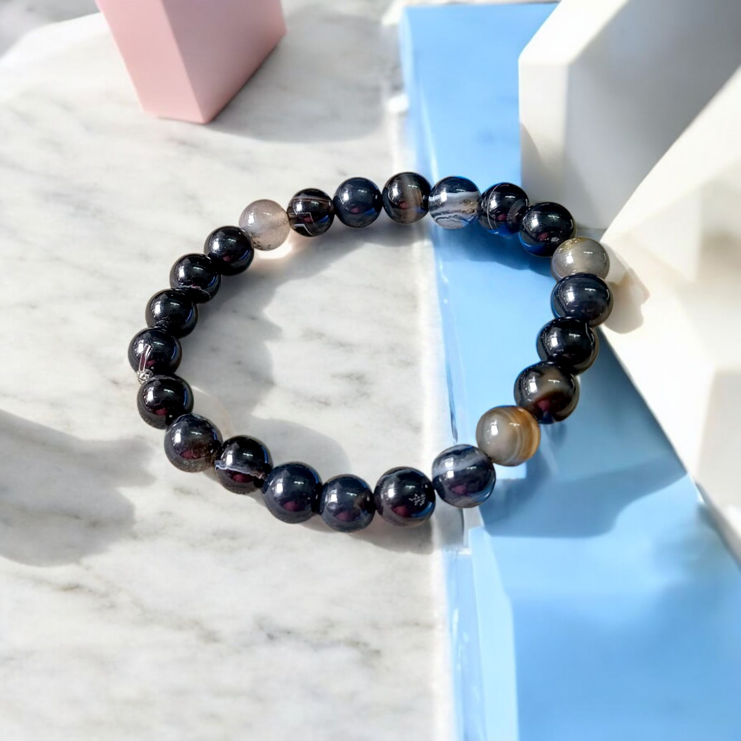 Image of a Natural Sulemani Hakik Bracelet with 8MM round Black Agate beads, stretchable to fit most wrists, designed for healing, protection, and daily wear