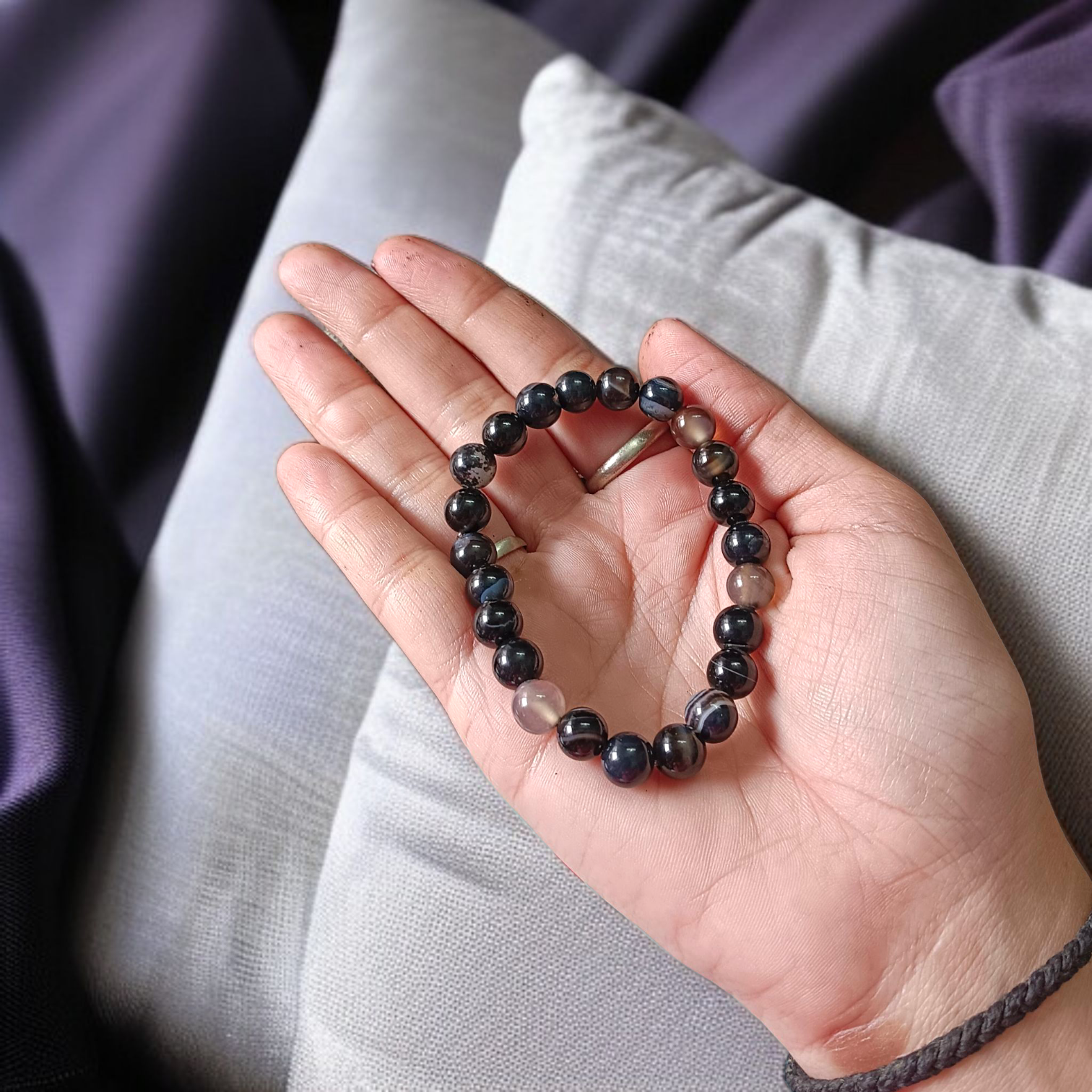 Image of a Natural Sulemani Hakik Bracelet with 8MM round Black Agate beads, stretchable to fit most wrists, designed for healing, protection, and daily wear