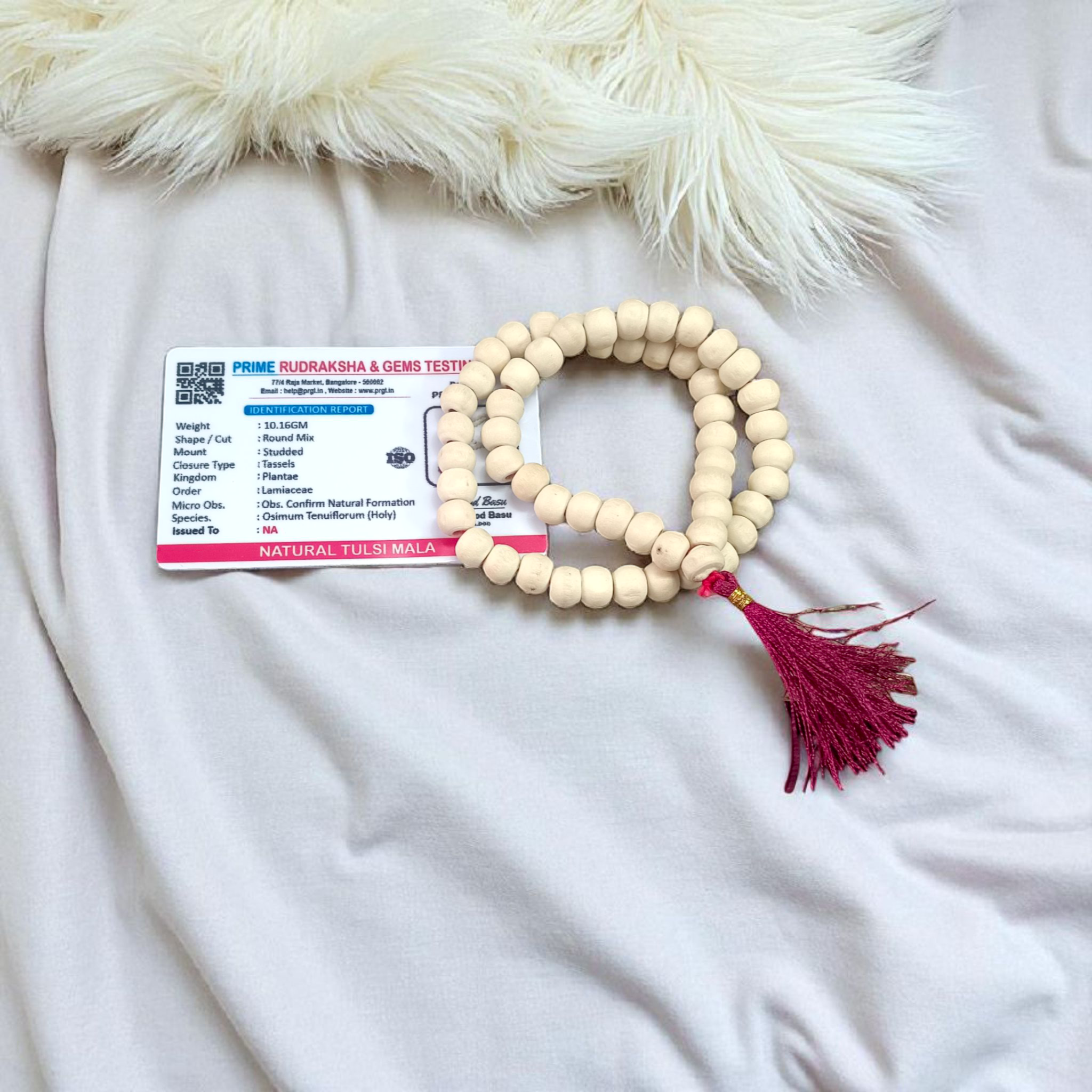 Image of a handcrafted Natural Tulsi Mala with 54+1 beads, 8mm size, laid neatly on a wooden surface with a spiritual setting background