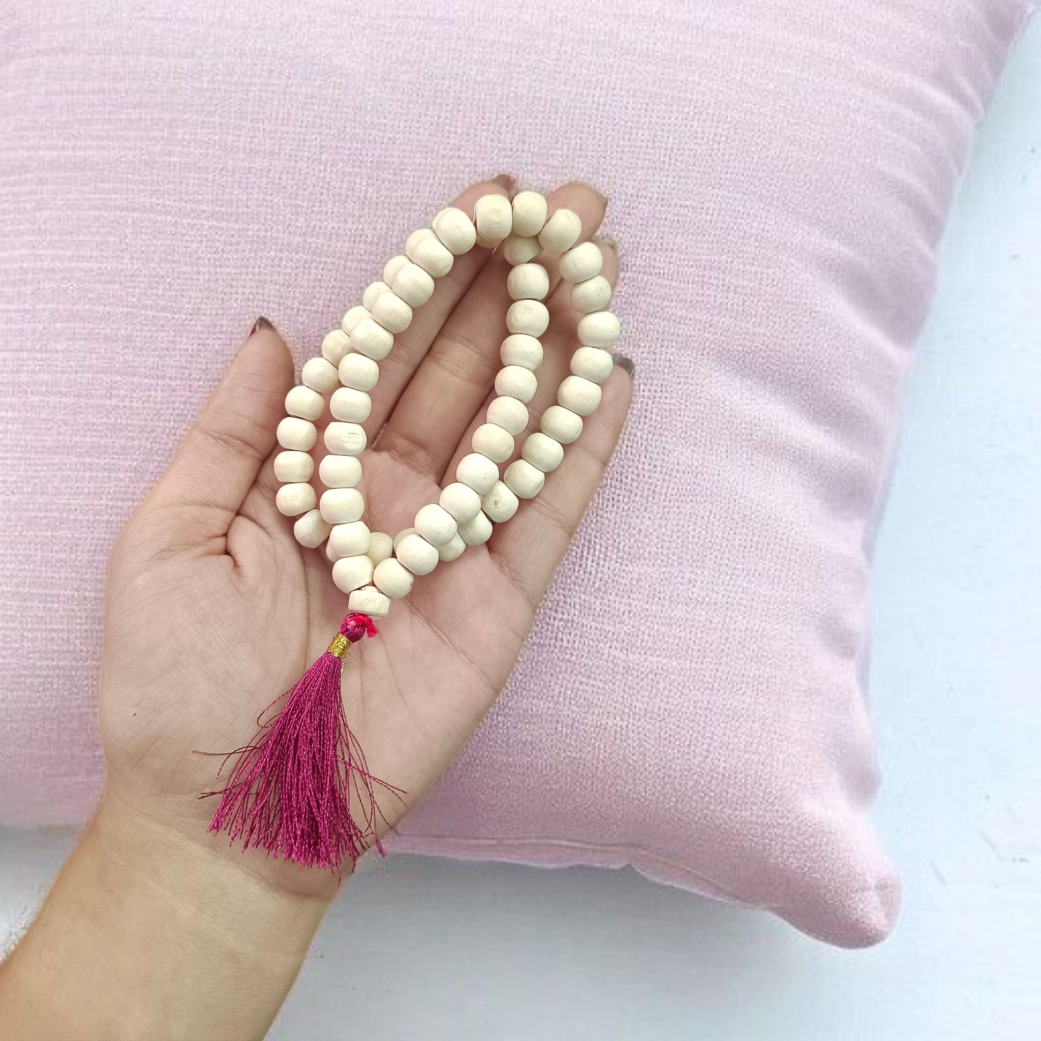Image of a handcrafted Natural Tulsi Mala with 54+1 beads, 8mm size, laid neatly on a wooden surface with a spiritual setting background