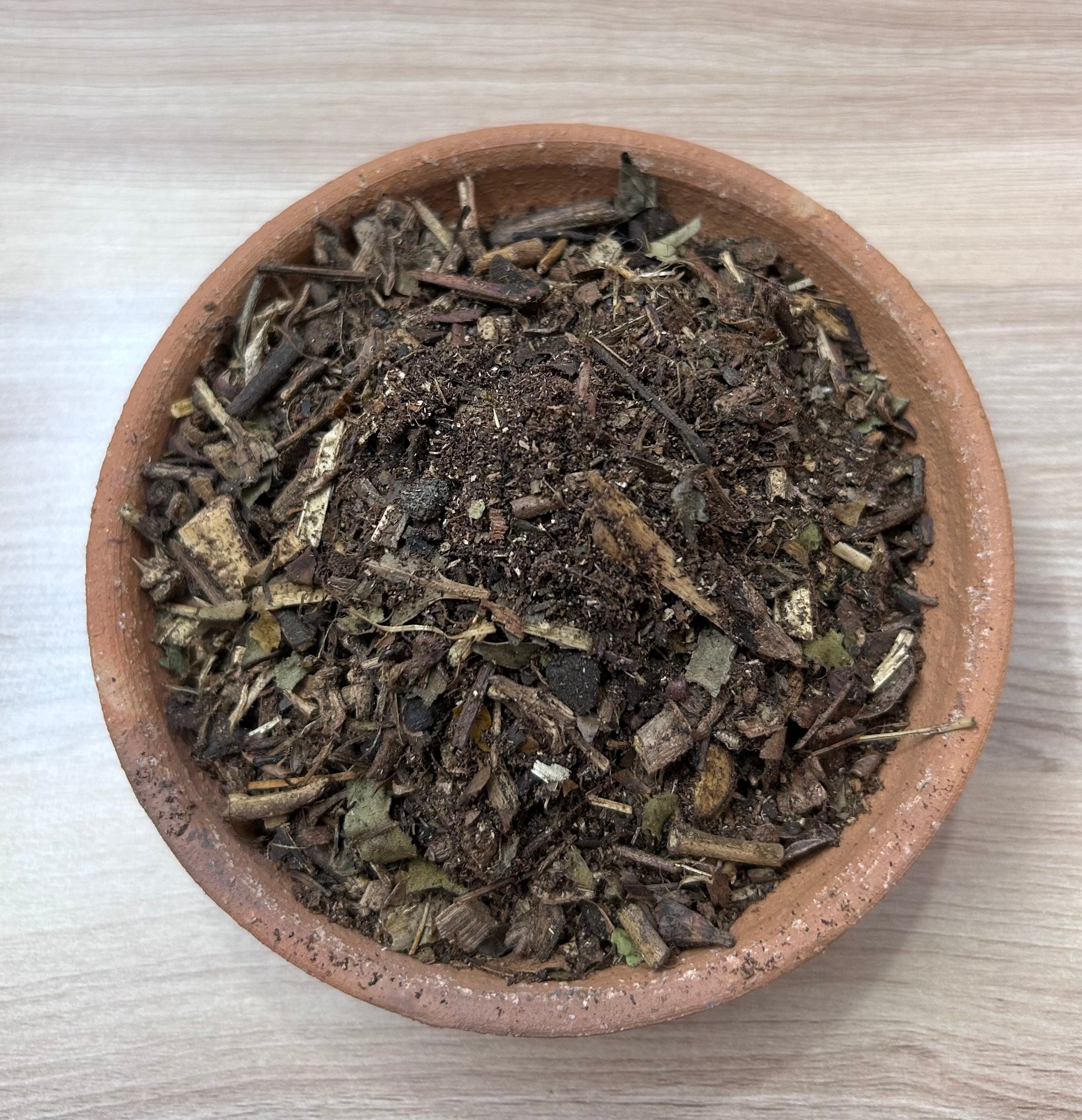 Image showing a 500GM pack of Hawan Samagri containing colorful natural herbs and powders used for Vedic rituals, placed beside puja essentials