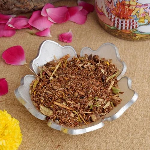 Image showing a 500GM pack of Hawan Samagri containing colorful natural herbs and powders used for Vedic rituals, placed beside puja essentials