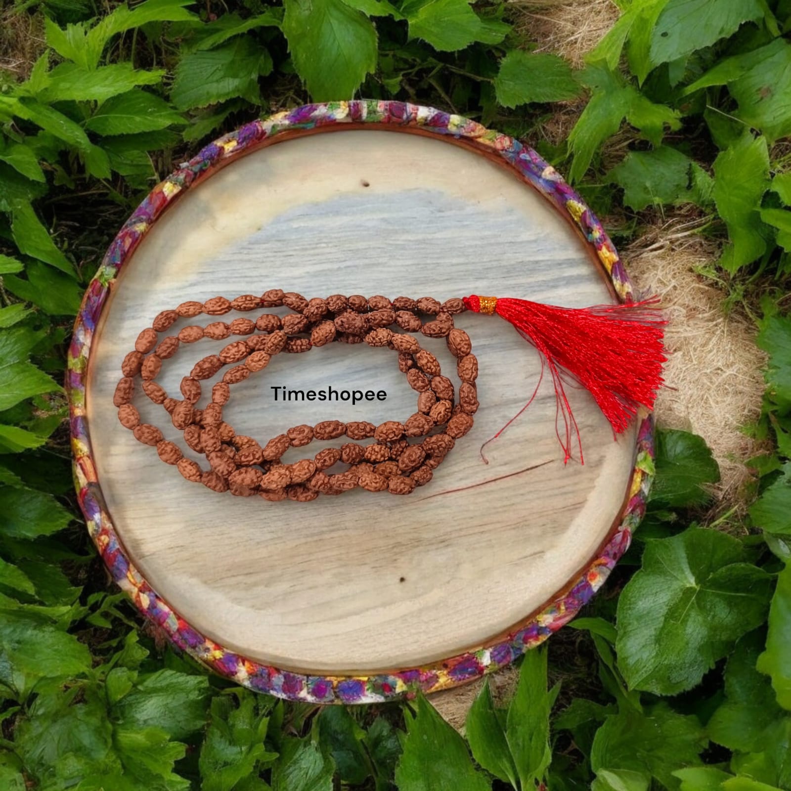 Image showing a hand-crafted 2 Mukhi Rudraksha Mala in 108+1 bead variant, lab certified and neatly arranged on a traditional cloth background with Timeshopee tag.