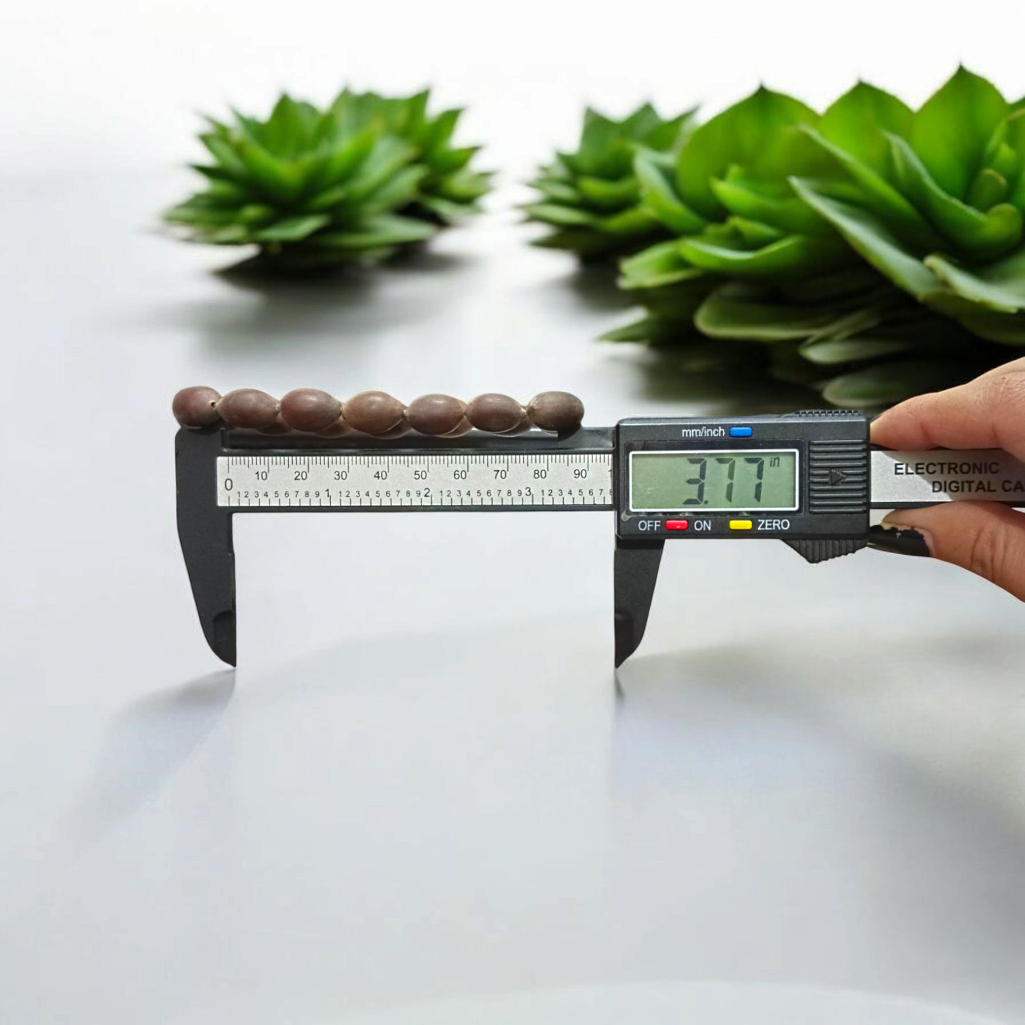 Image showing a handcrafted Kamal Gutta Bracelet made from 100% original lotus seeds, placed on a spiritual background with natural light.