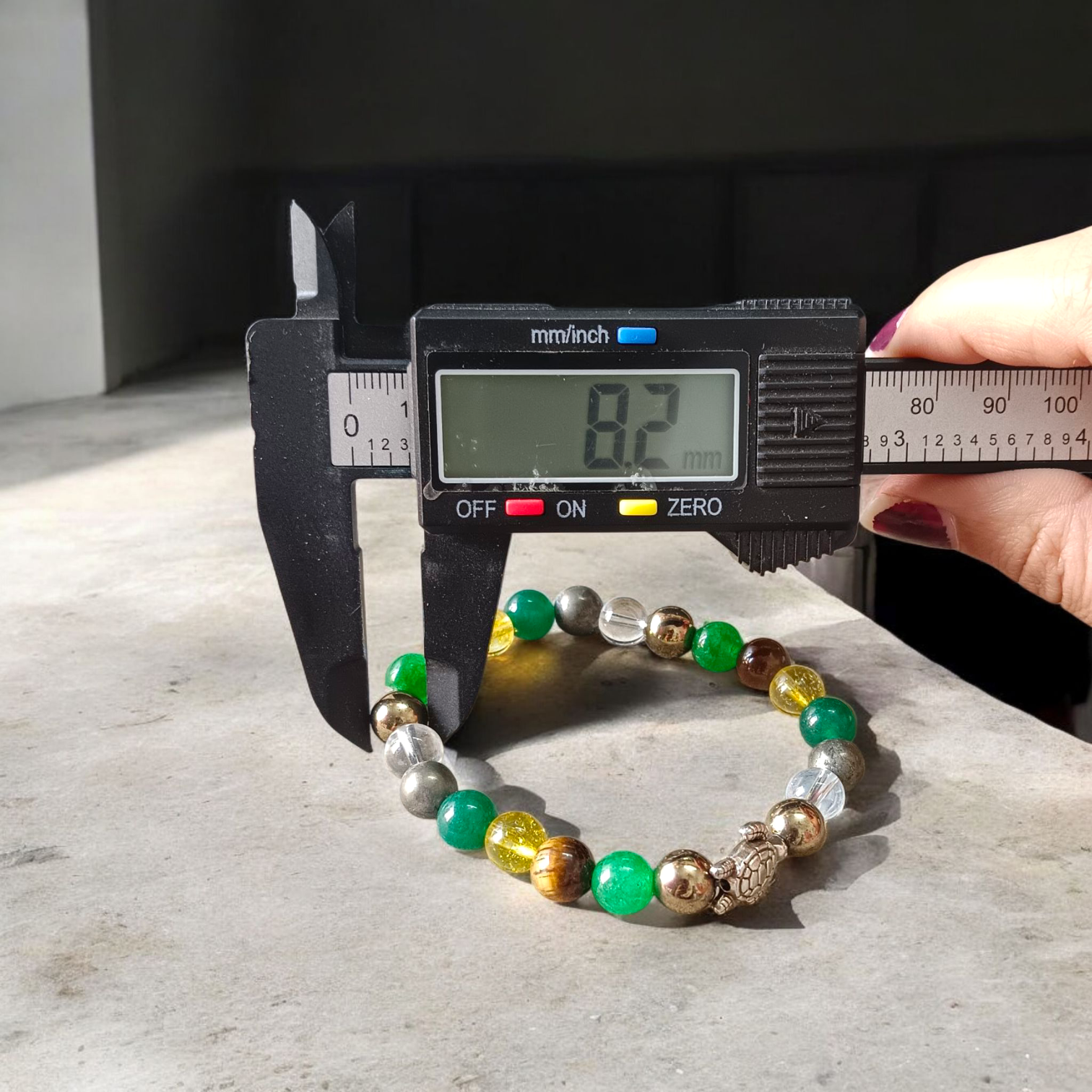 Image showing a stylish 8mm bead Money Magnet Bracelet with stretchable band, ideal for daily wear or gifting, placed on a clean background