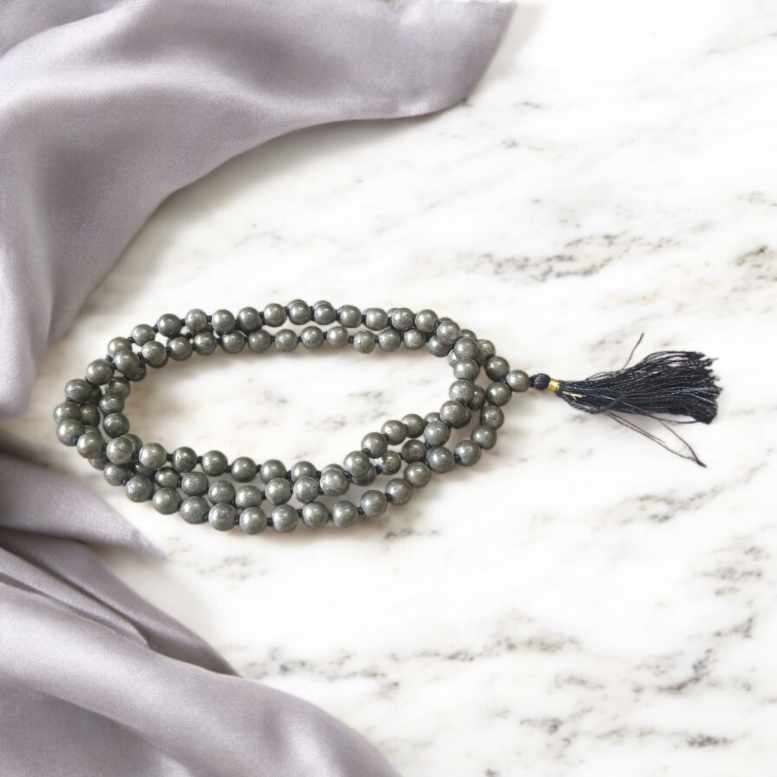 Lab-certified Natural Raw Pyrite Mala (108+1 beads, 8MM) with metallic golden finish, placed on a white background with spiritual packaging