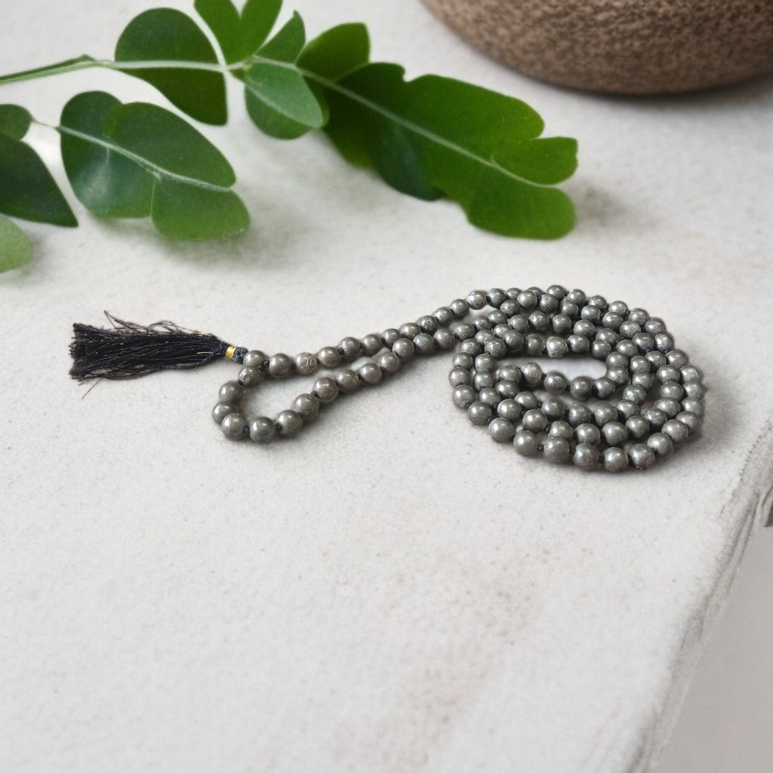 Lab-certified Natural Raw Pyrite Mala (108+1 beads, 8MM) with metallic golden finish, placed on a white background with spiritual packaging