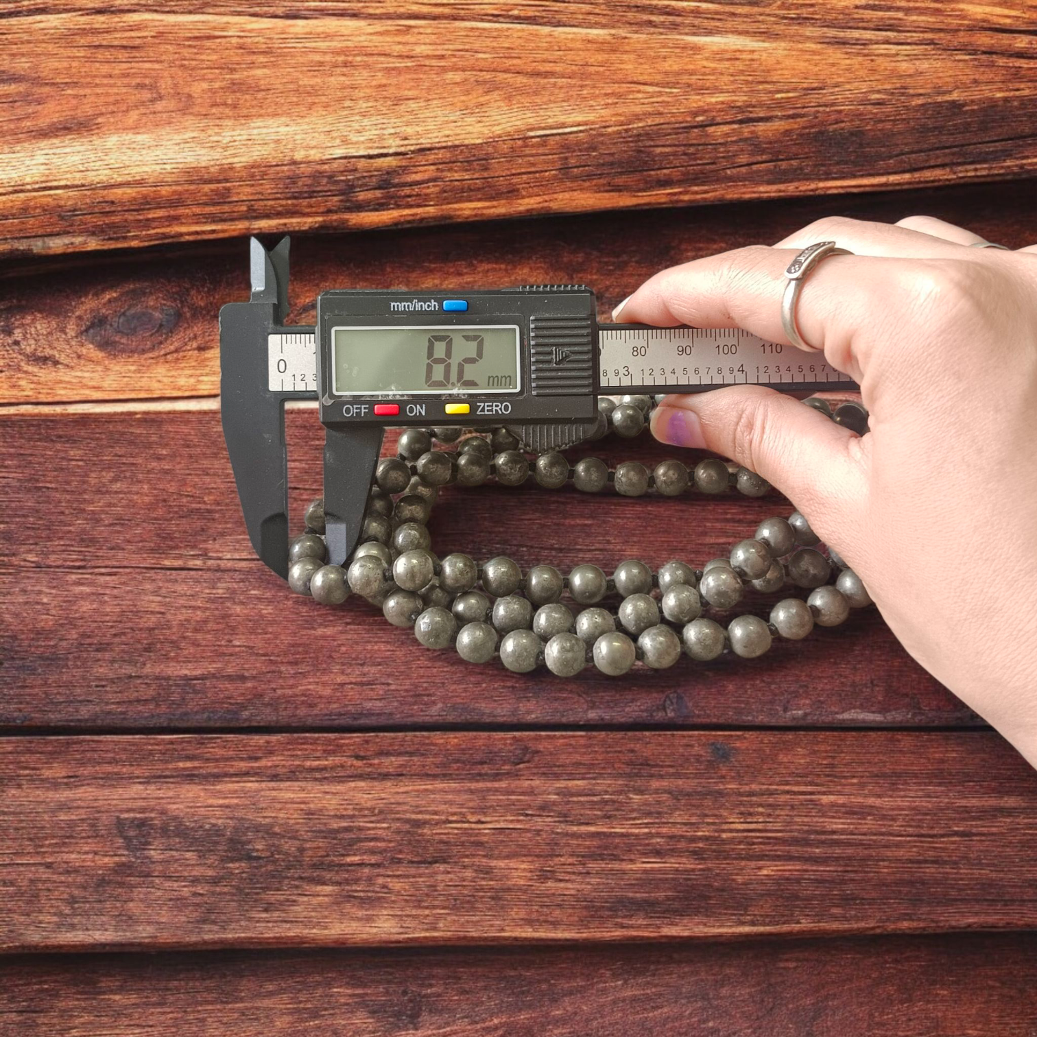 Lab-certified Natural Raw Pyrite Mala (108+1 beads, 8MM) with metallic golden finish, placed on a white background with spiritual packaging