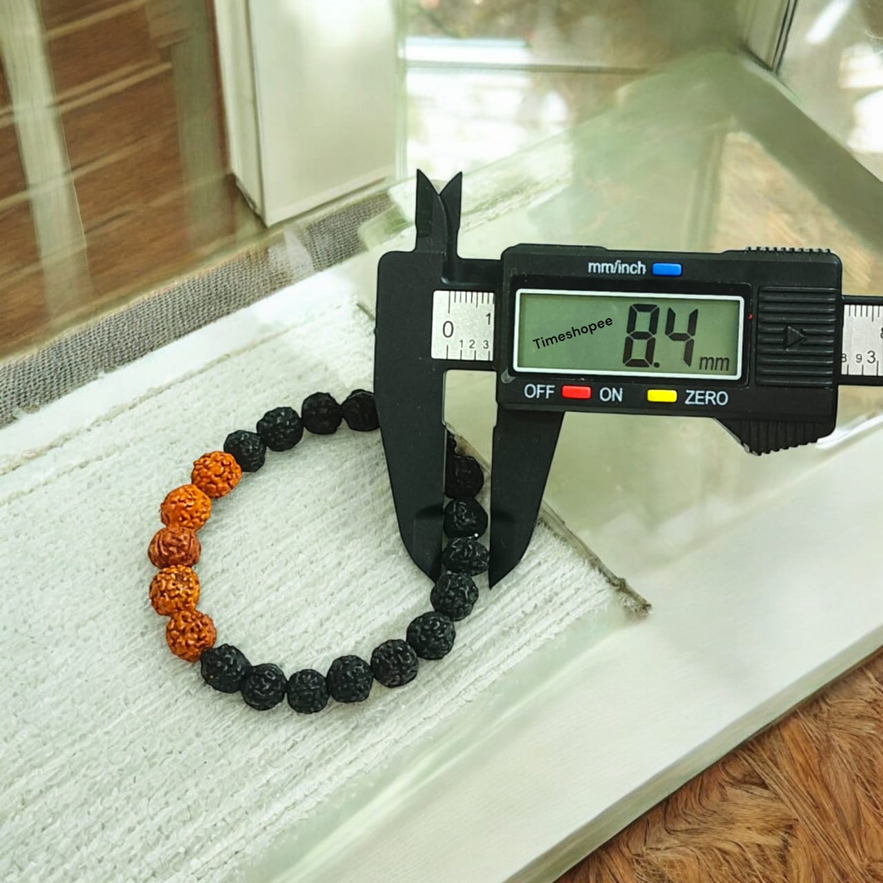 Lab certified 5 Mukhi Rudraksha bracelet in a black and brown mix with 6-8 mm beads, featuring a stretchable design for comfortable wear.