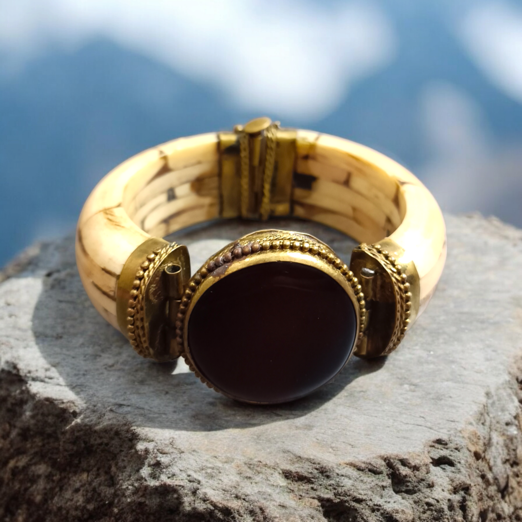 Lal Hakik Bracelet featuring red agate stone set in antique brass cuff, accompanied by lab certificate.