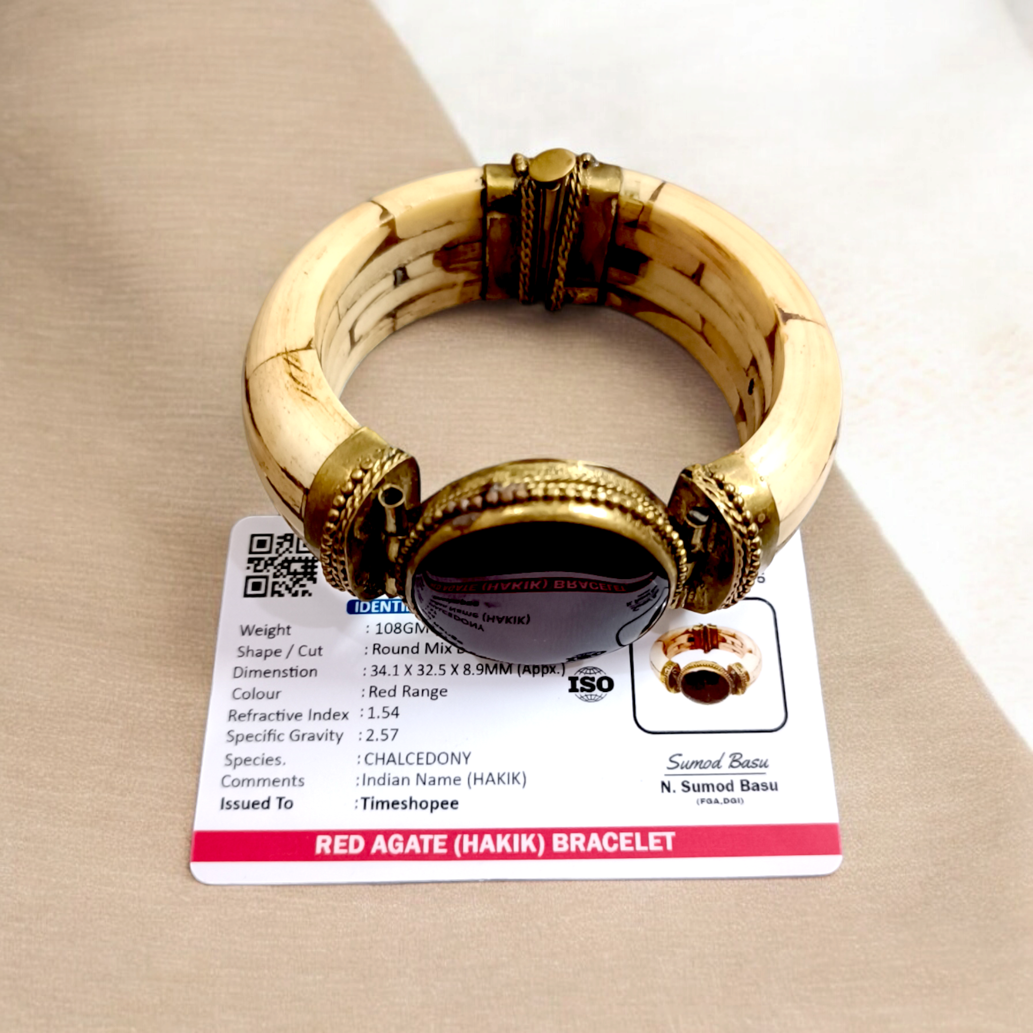 Lal Hakik Bracelet featuring red agate stone set in antique brass cuff, accompanied by lab certificate.