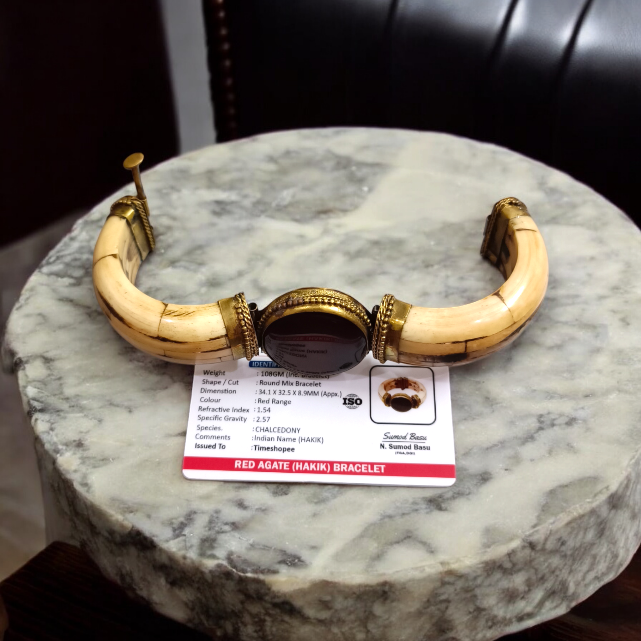 Lal Hakik Bracelet featuring red agate stone set in antique brass cuff, accompanied by lab certificate.