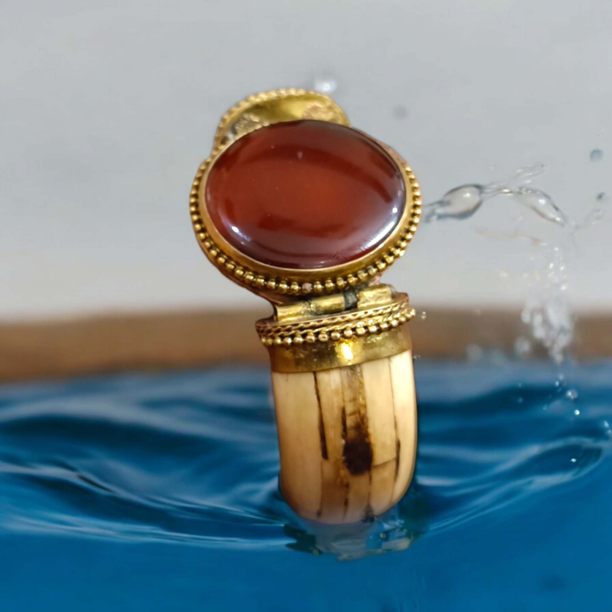 Lal Hakik Bracelet featuring red agate stone set in antique brass cuff, accompanied by lab certificate.