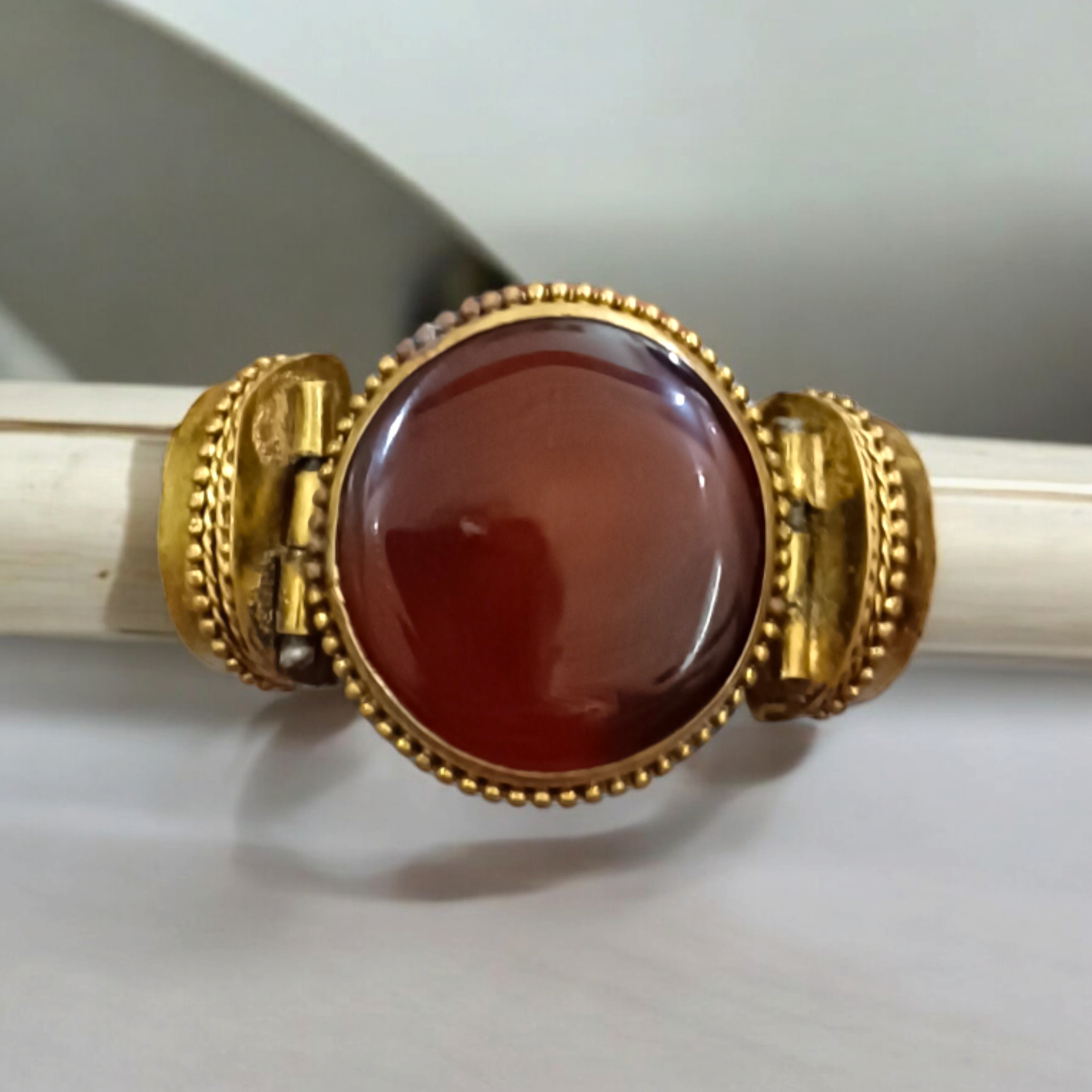 Lal Hakik Bracelet featuring red agate stone set in antique brass cuff, accompanied by lab certificate.