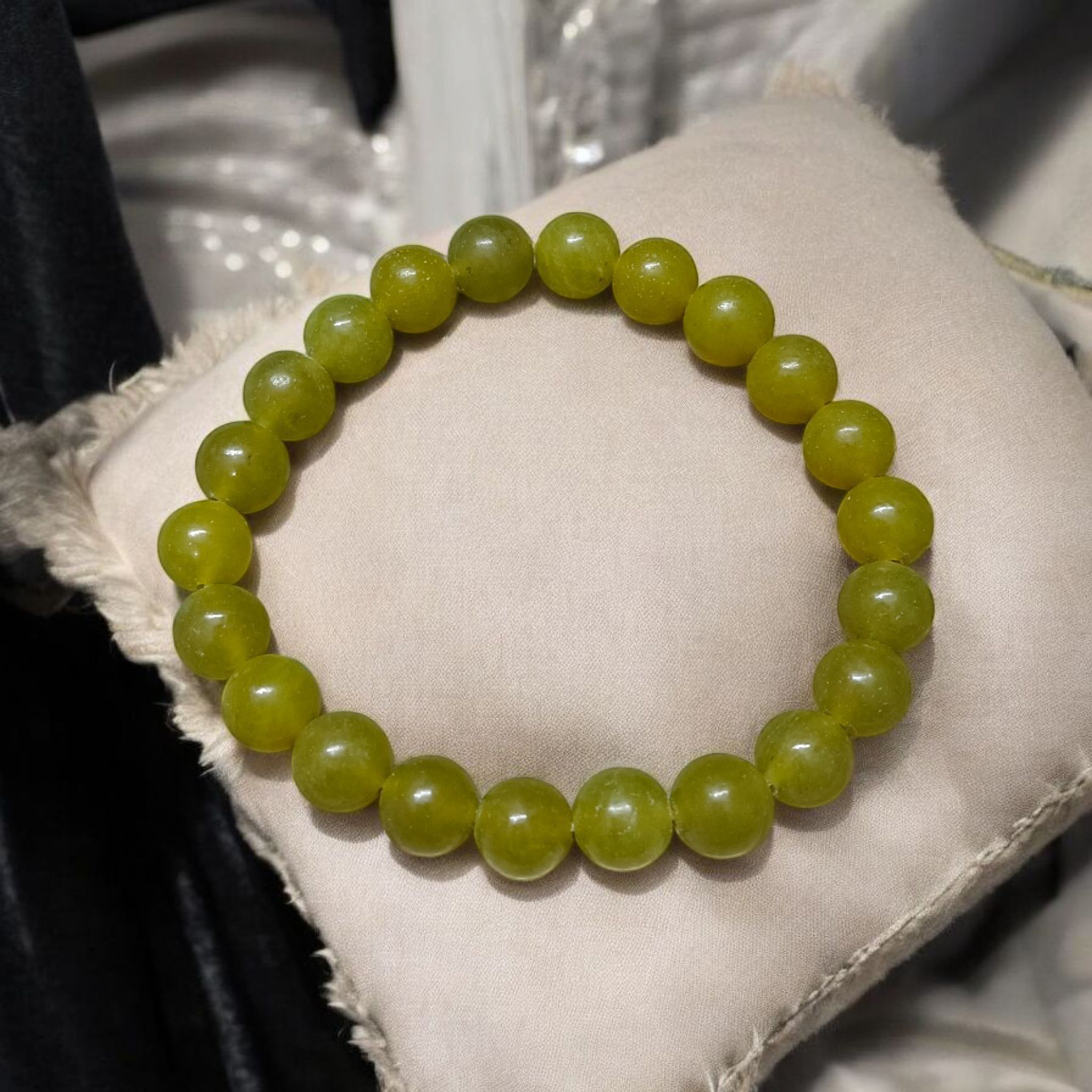 Light Green ONYX Bracelet with lab certificate, showcasing the elegant stretchable design and light green hue.