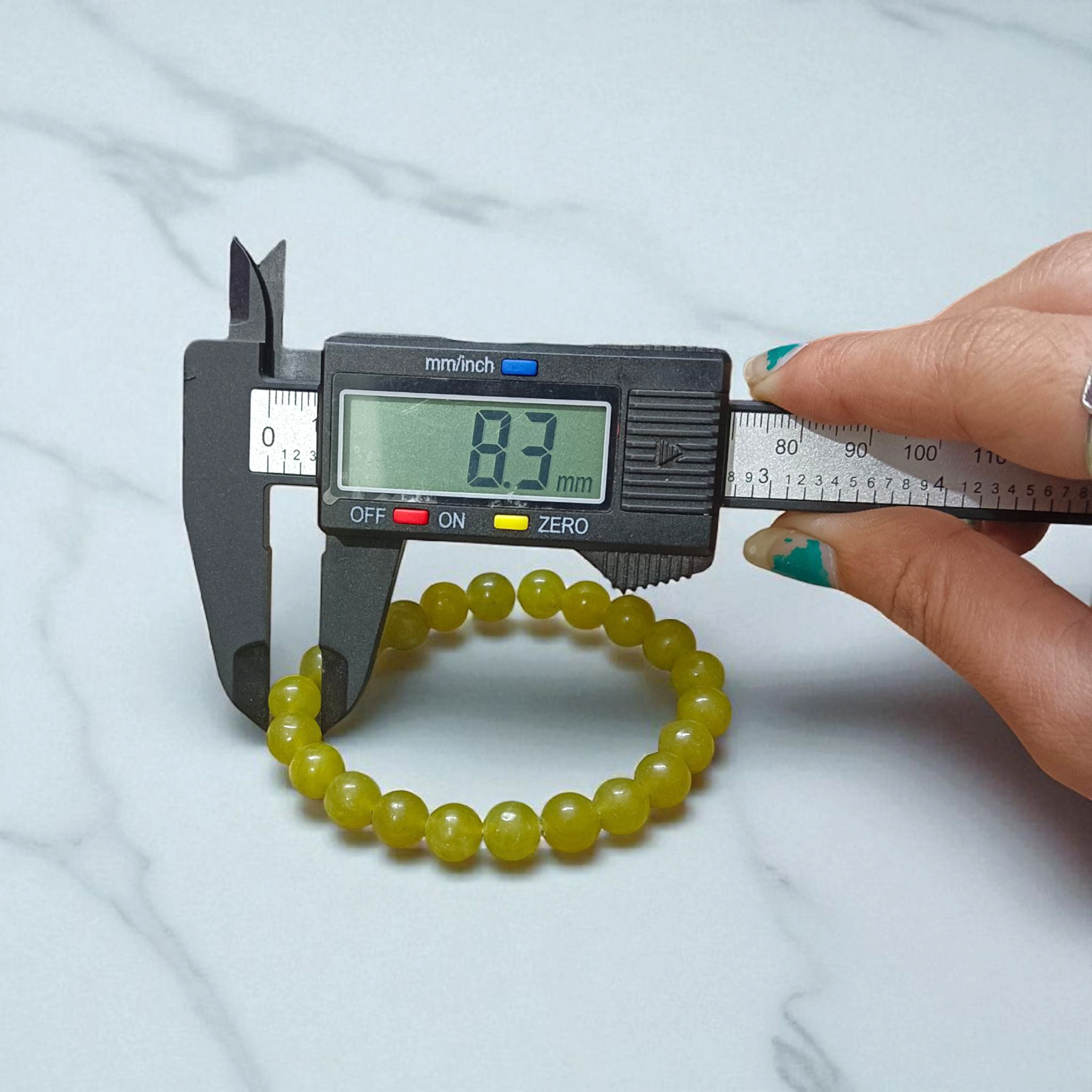 Light Green ONYX Bracelet with lab certificate, showcasing the elegant stretchable design and light green hue.