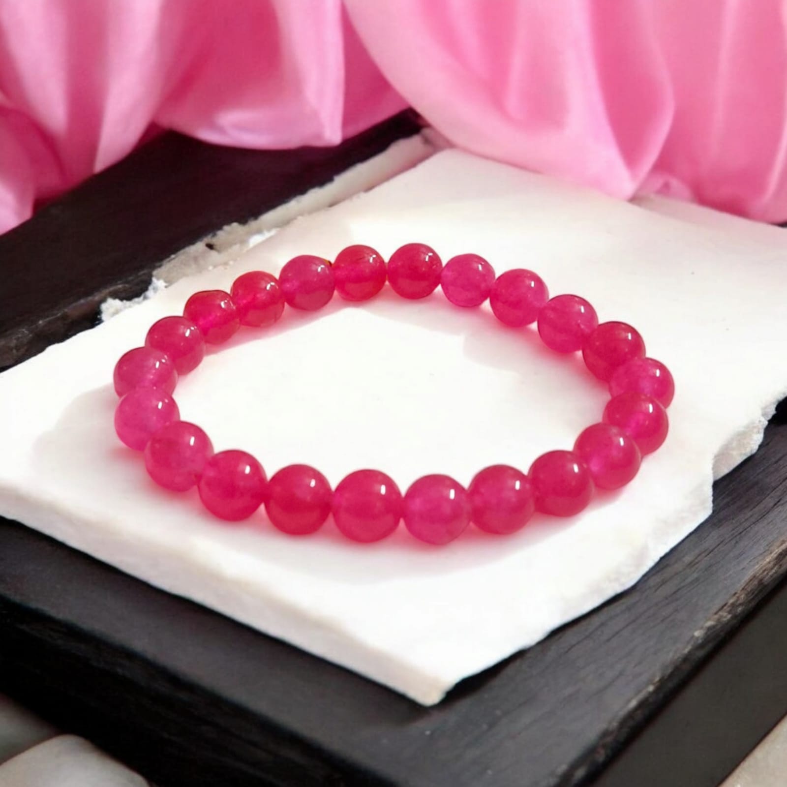 Light Pink ONYX Bracelet with lab certificate showing a close-up view of the elegant stretchable design.
