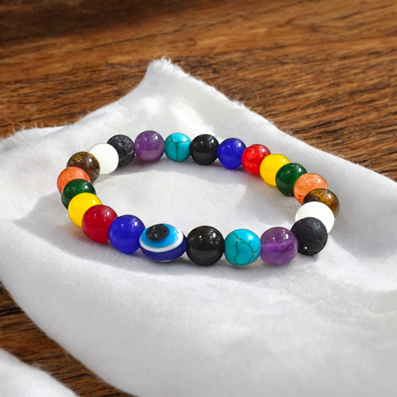 Mix Agate and 7 Chakra bracelet featuring colorful 8MM beads, including Agates, Lava, Amethyst, Tiger Eye, Turquoise, Hessonite, and an Evil Eye bead, offering balance and protection.