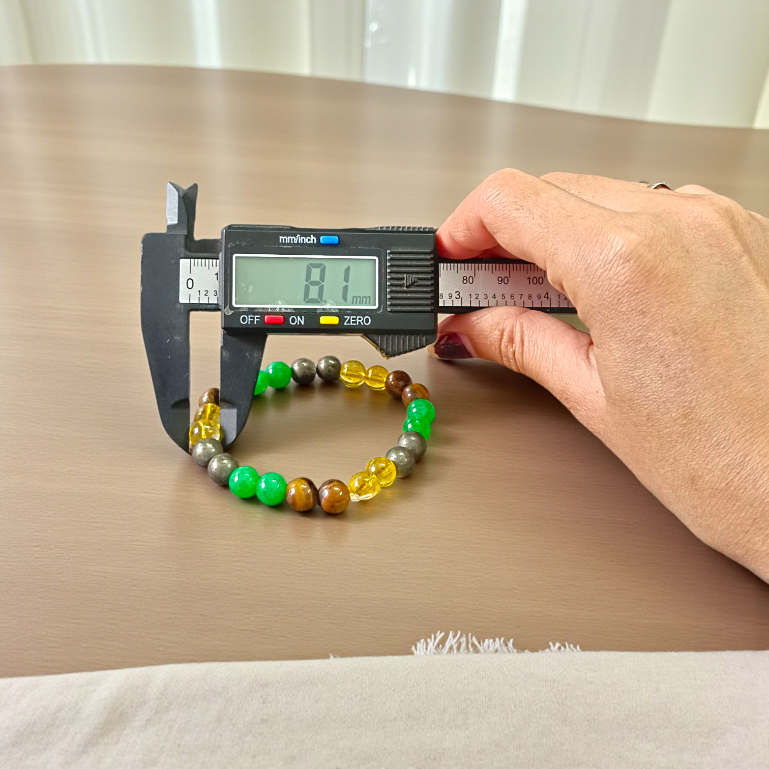 Money Magnet Bracelet made of 8mm lab-certified magnetic beads with stretchable design, used for attracting wealth, luck, and financial success