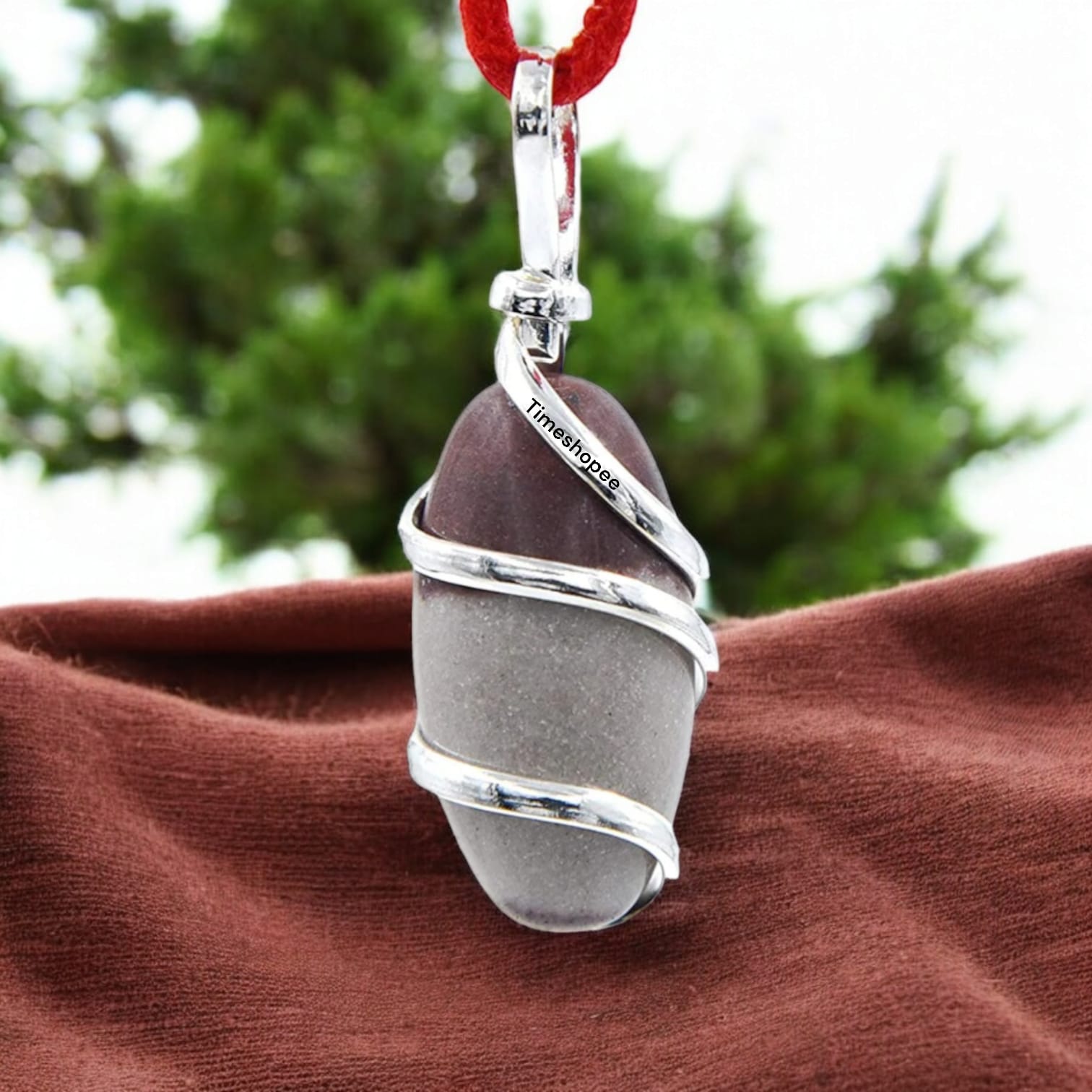 Narmadeshwar Shivling Pendant with red knotted thread, lab certified, made from Narmada river stone.