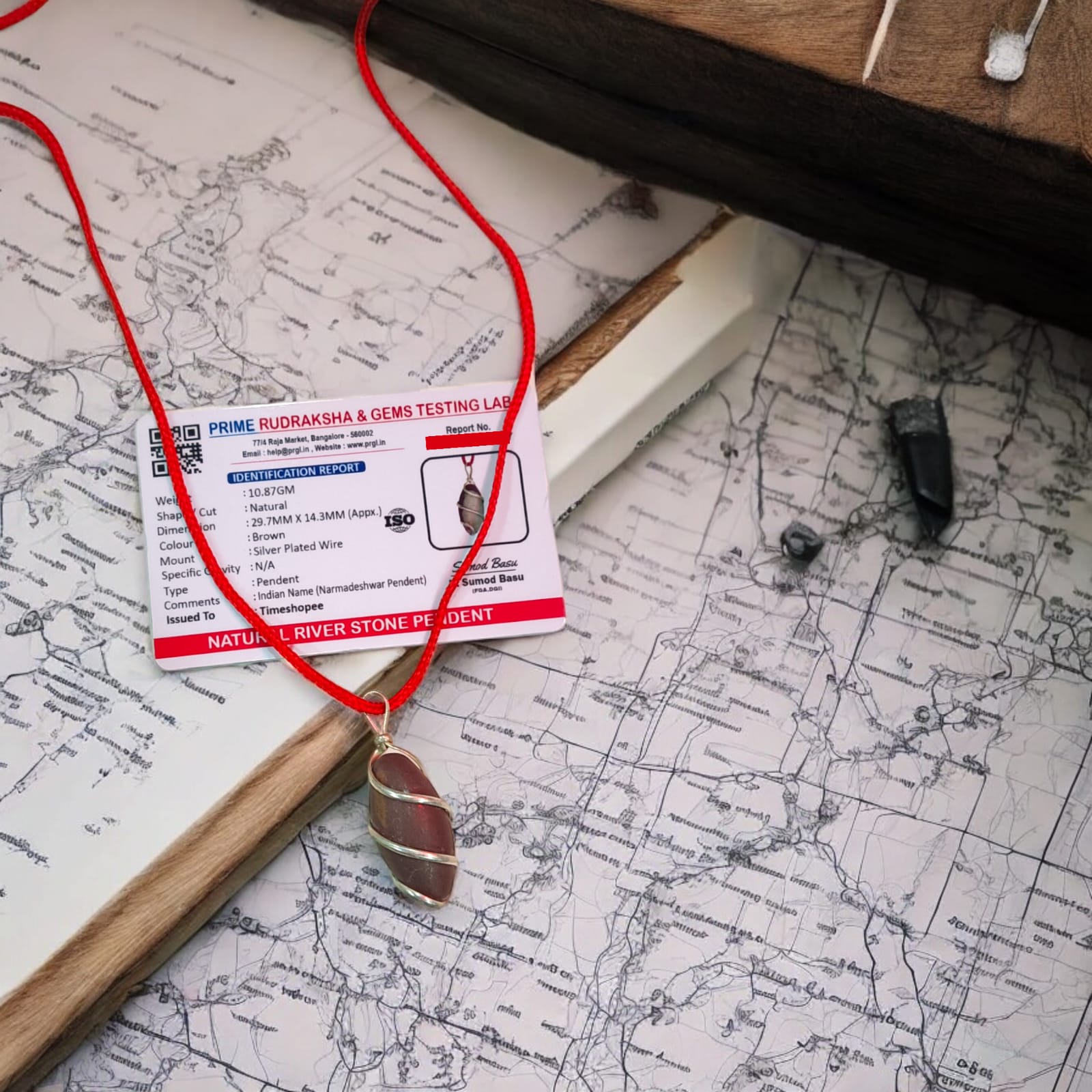 Narmadeshwar Shivling Pendant with red knotted thread, lab certified, made from Narmada river stone.