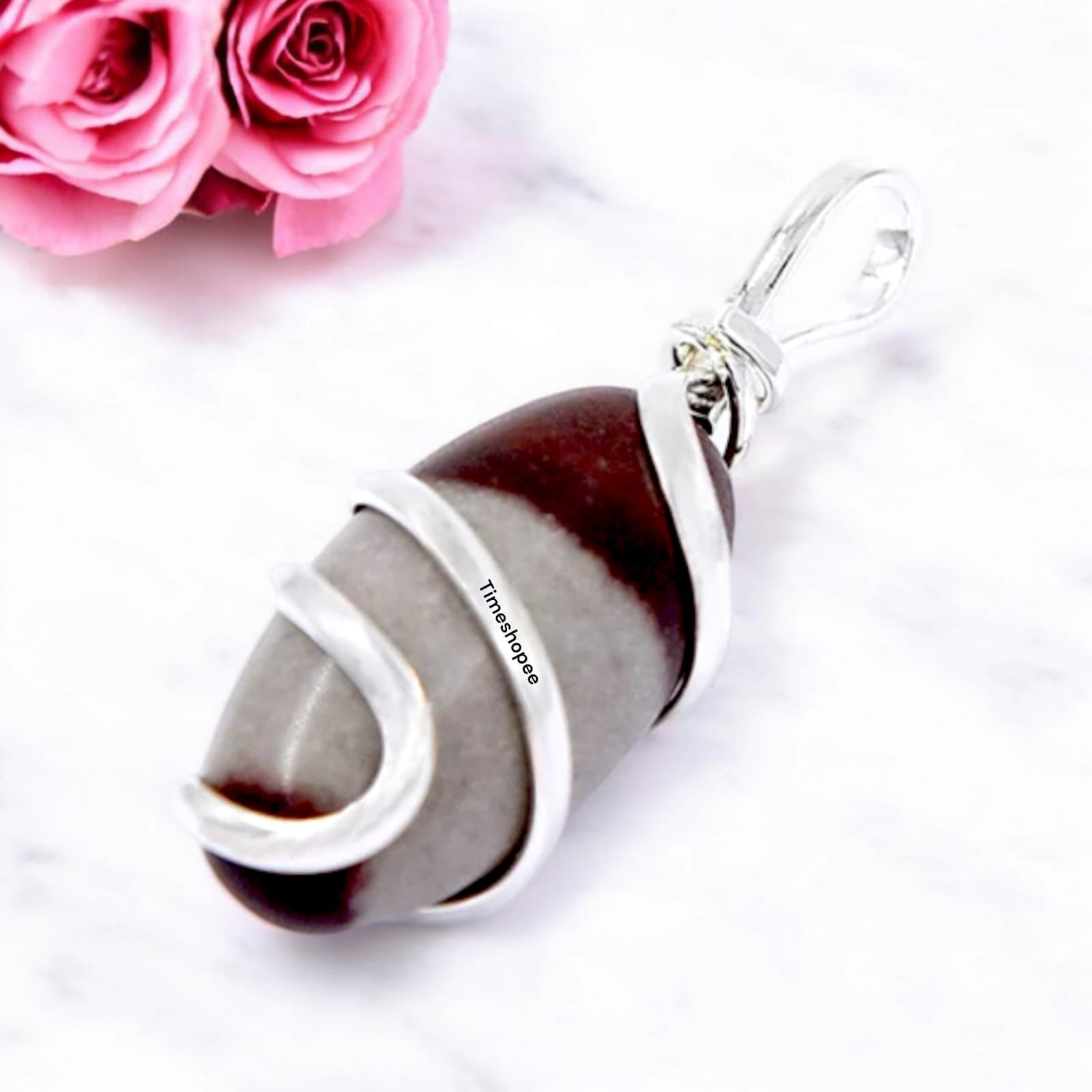 Narmadeshwar Shivling Pendant with red knotted thread, lab certified, made from Narmada river stone.