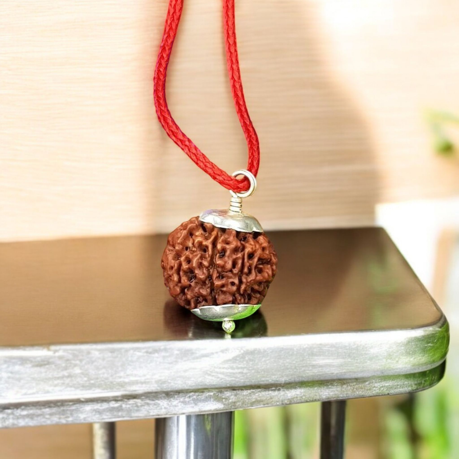 Natural 8 Mukhi Rudraksha Locket with silver capping displayed with certification from Timeshopee