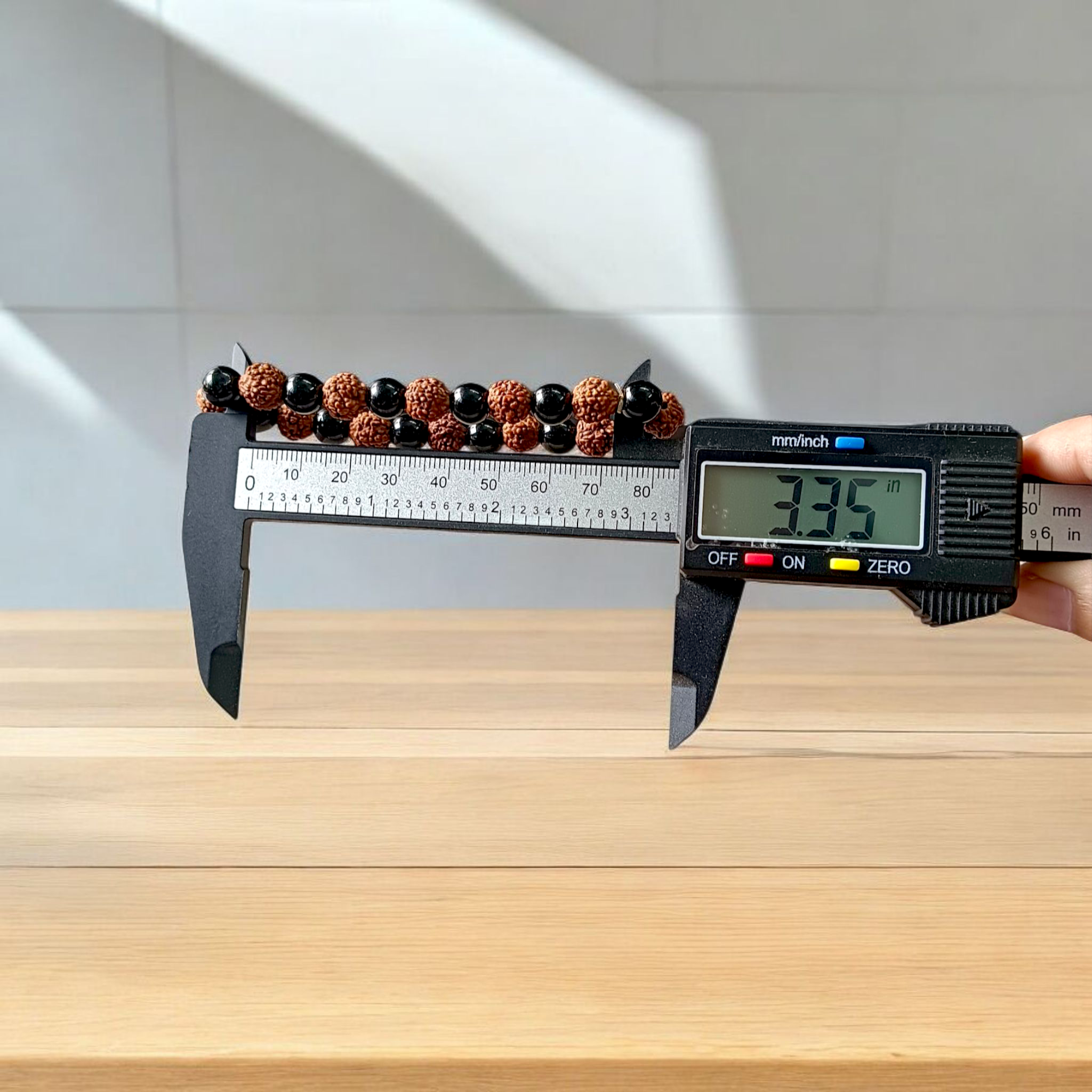 Natural Agate and 5 Mukhi Rudraksha bracelet with black and brown beads on a white background