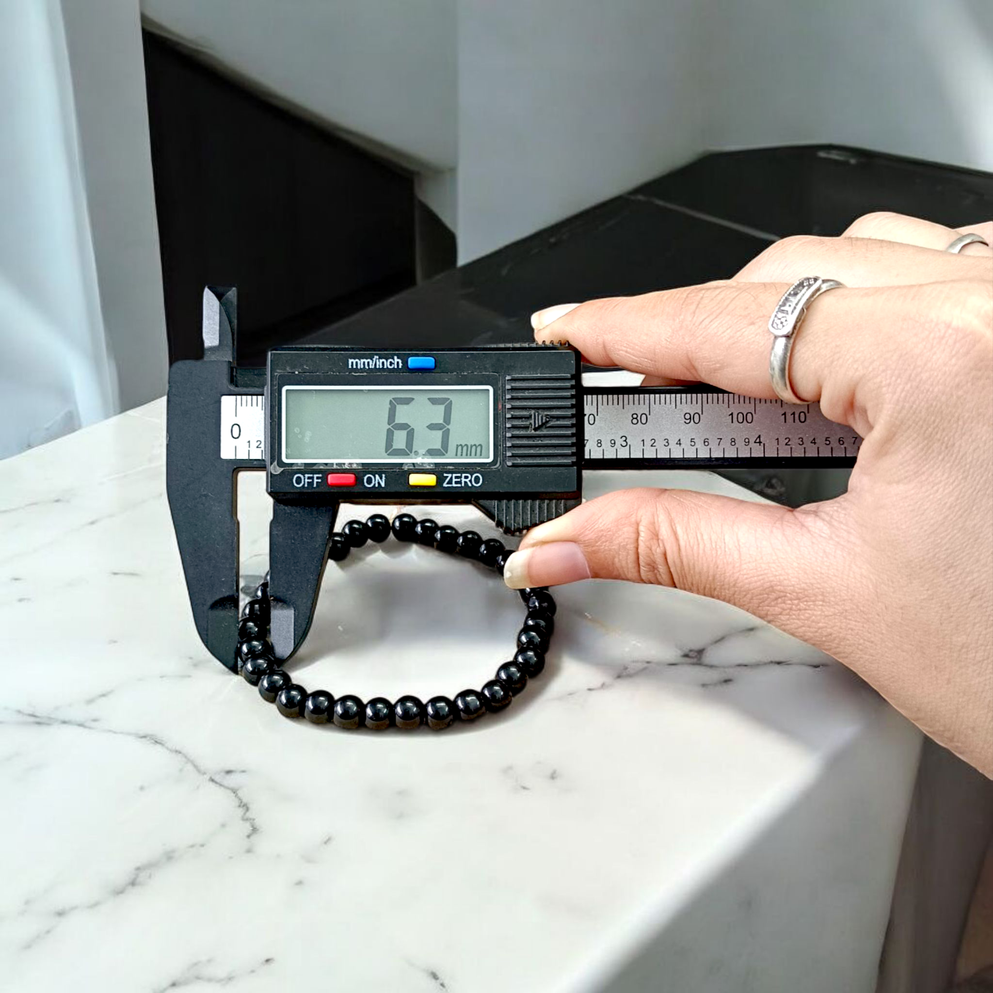 Natural Black Agate Bracelet with 6mm beads, stretchable, displayed on a neutral background