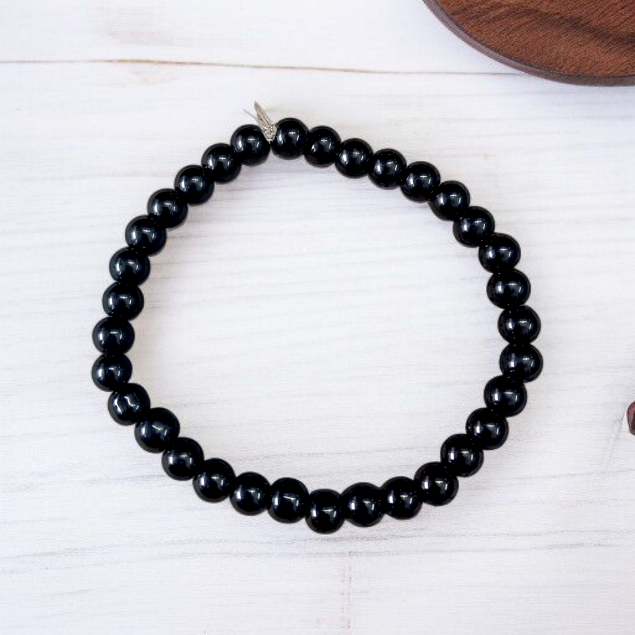 Natural Black Agate Bracelet with 6mm beads, stretchable, displayed on a neutral background