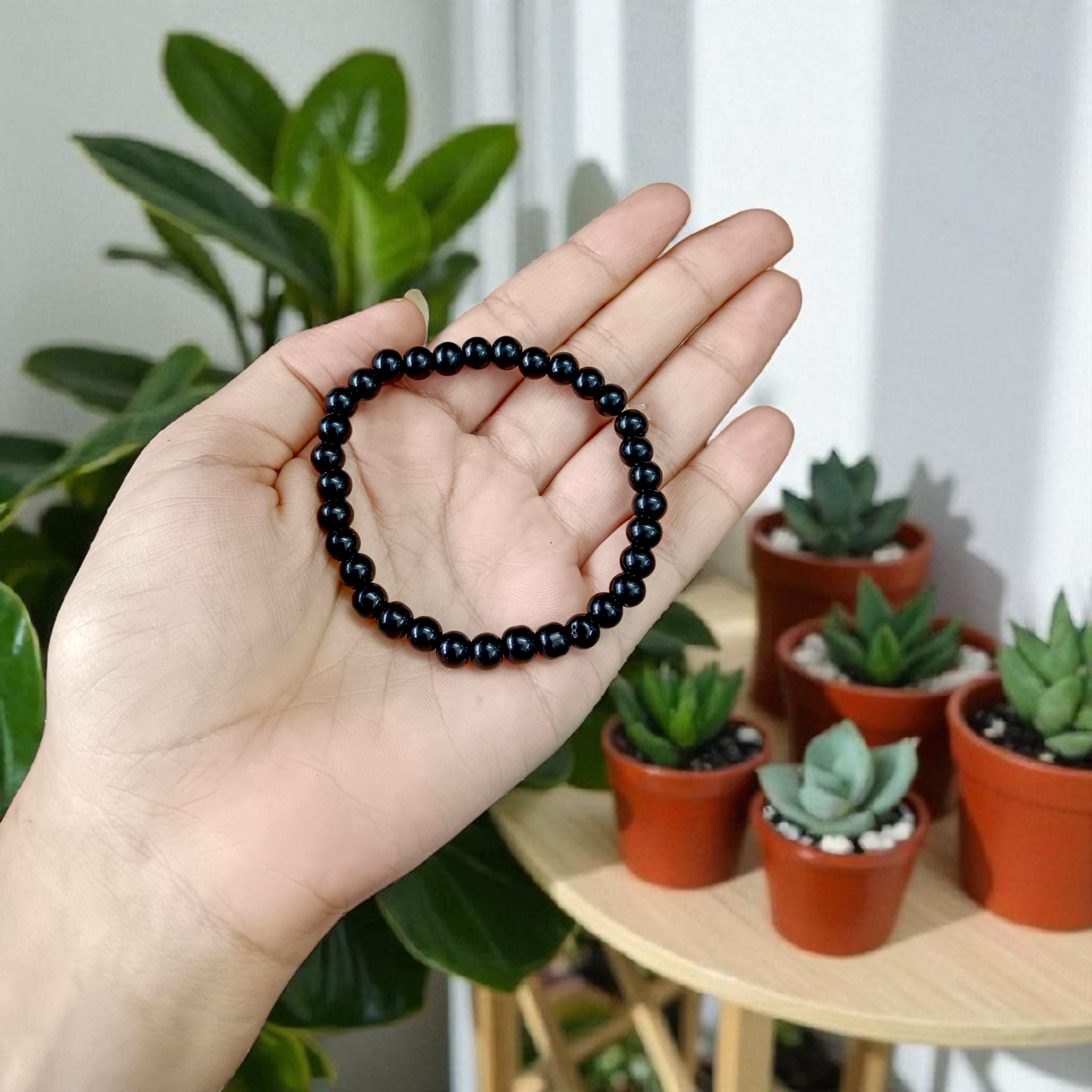 Natural Black Agate Bracelet with 6mm beads, stretchable, displayed on a neutral background