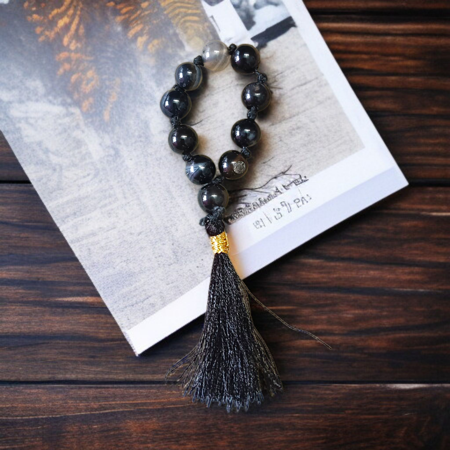 Natural Black Sulemani Finger Mala with 9+1 round 8mm beads displayed on a soft background, ideal for meditation, mantra chanting, and prayer