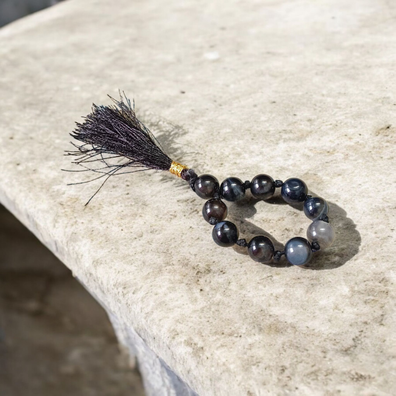 Natural Black Sulemani Finger Mala with 9+1 round 8mm beads displayed on a soft background, ideal for meditation, mantra chanting, and prayer