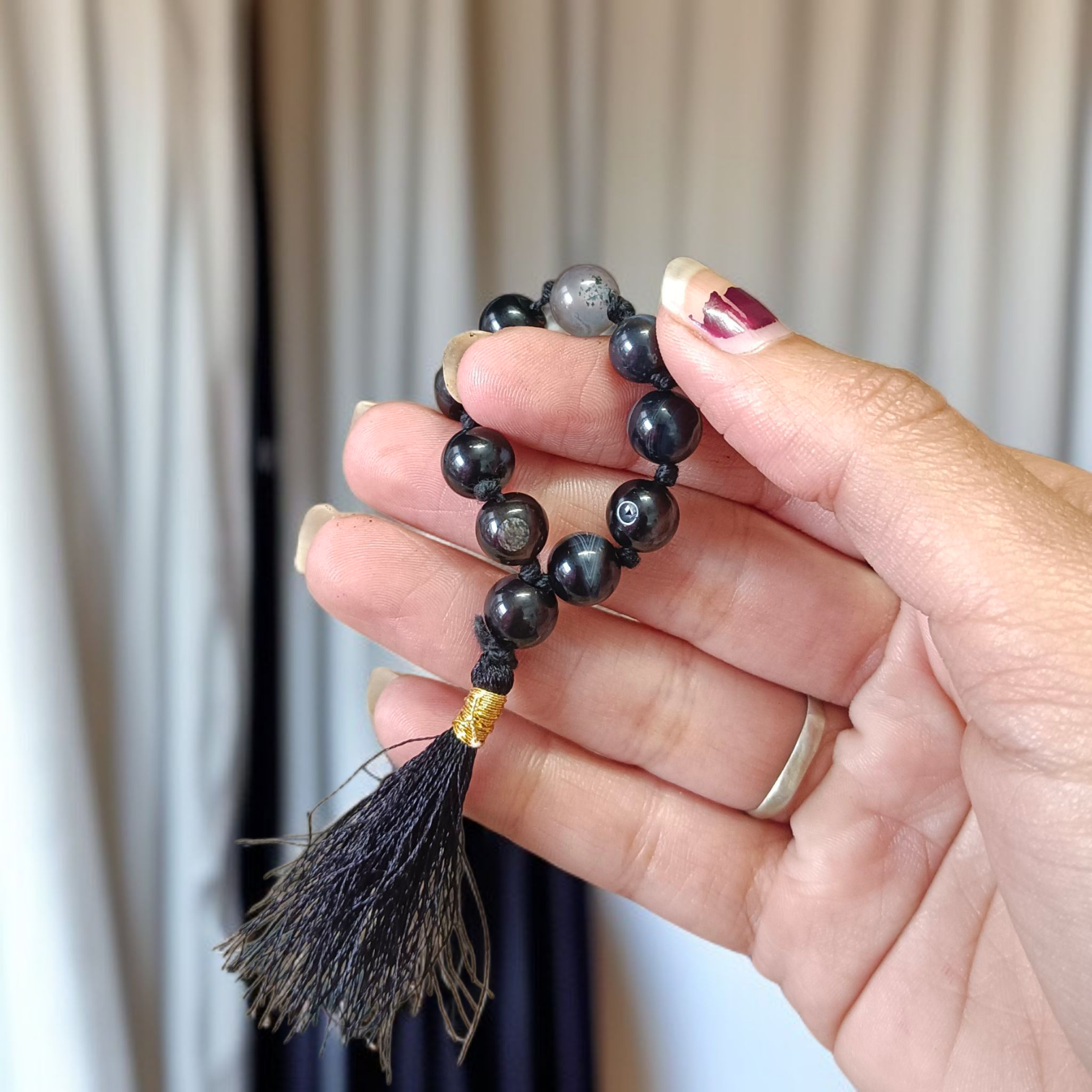 Natural Black Sulemani Finger Mala with 9+1 round 8mm beads displayed on a soft background, ideal for meditation, mantra chanting, and prayer