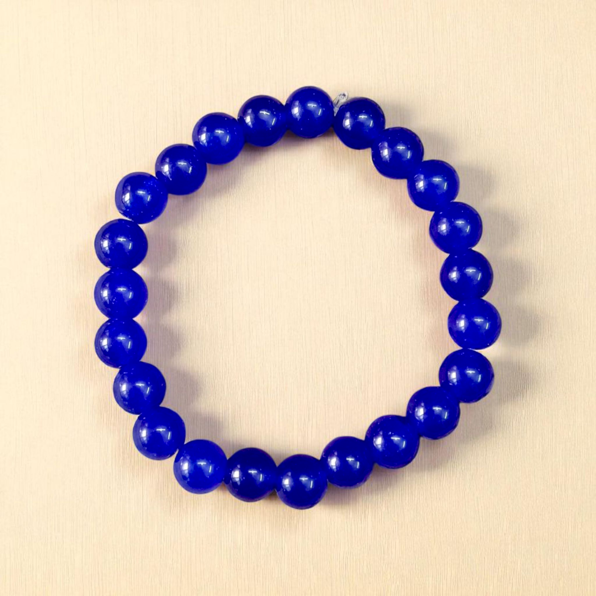 Natural Blue Agate (Hakik) Bracelet with 8mm round beads on a stretchable elastic cord, displayed in hand for spiritual and daily wear