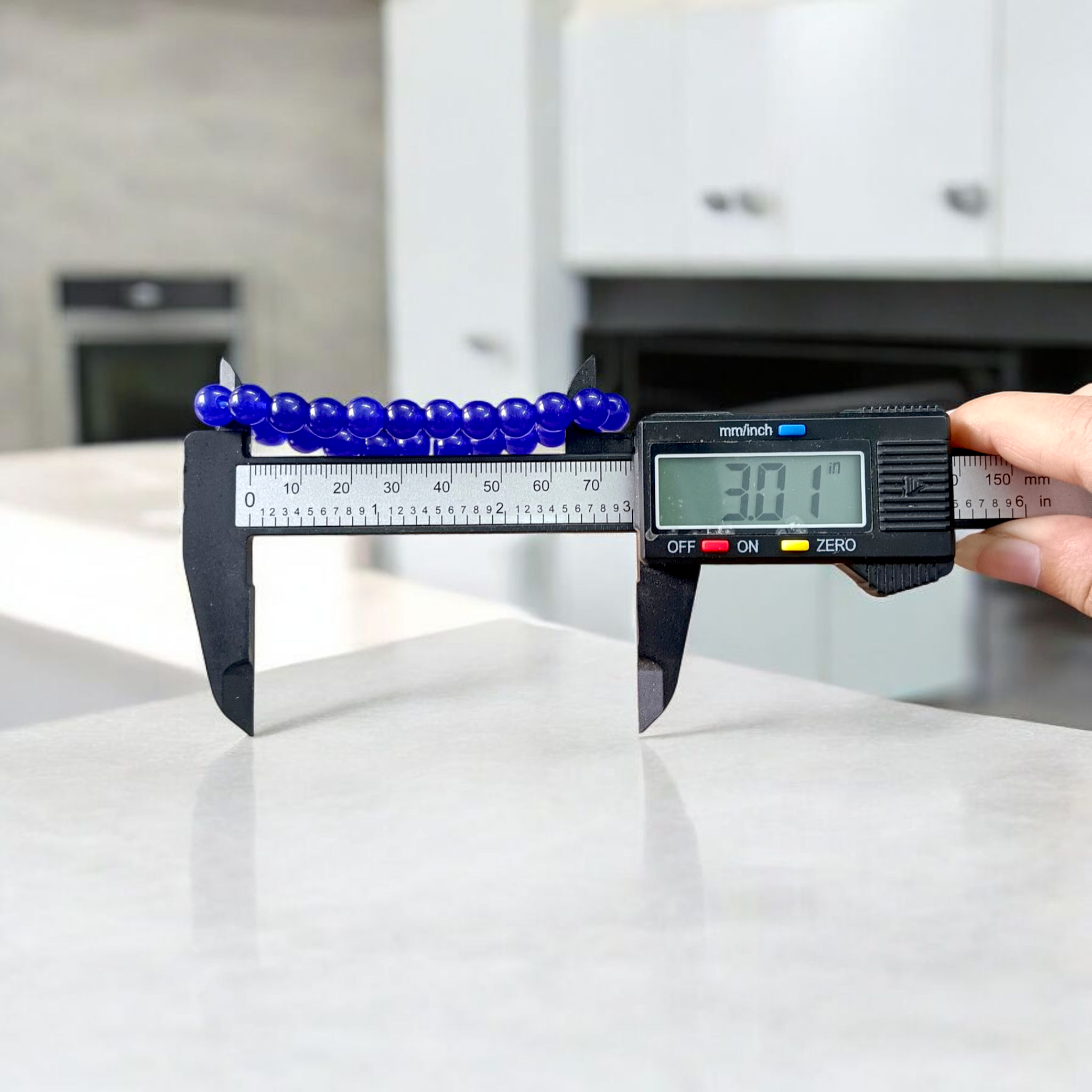 Natural Blue Agate (Hakik) Bracelet with 8mm round beads on a stretchable elastic cord, displayed in hand for spiritual and daily wear