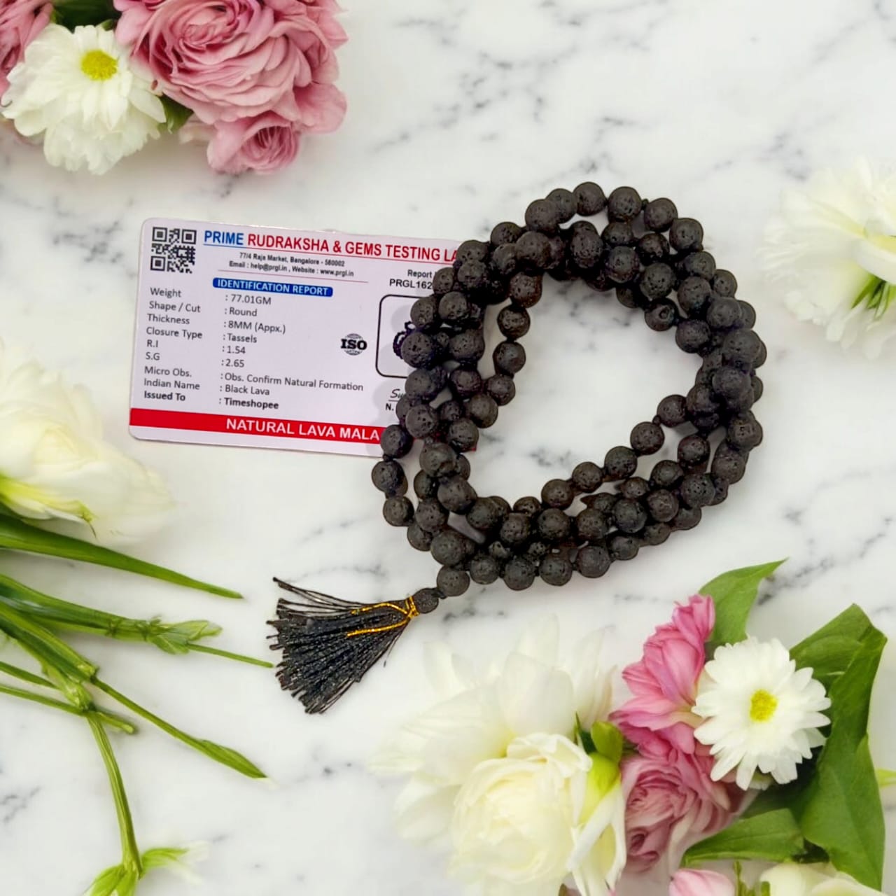 Natural Lava Mala with 108+1 volcanic beads, black porous texture, ideal for spiritual healing, placed on a white background