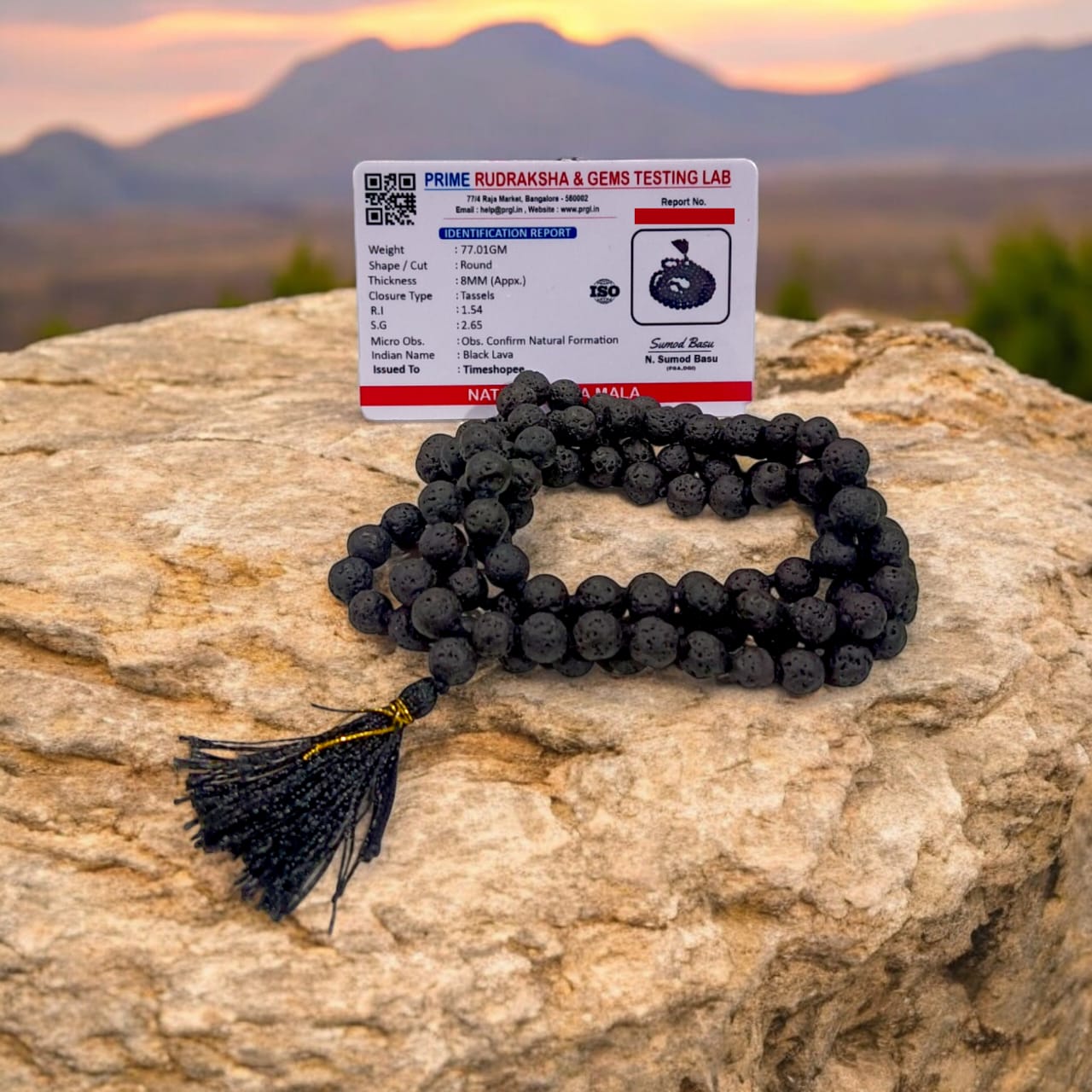 Natural Lava Mala with 108+1 volcanic beads, black porous texture, ideal for spiritual healing, placed on a white background