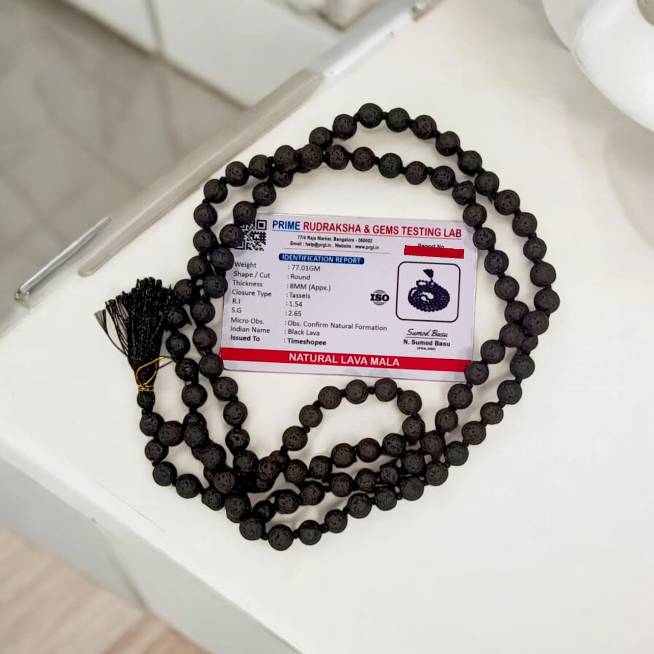 Natural Lava Mala with 108+1 volcanic beads, black porous texture, ideal for spiritual healing, placed on a white background