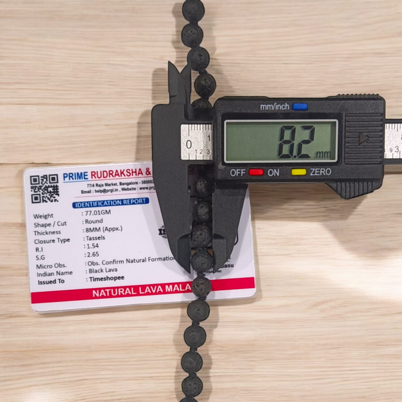 Natural Lava Mala with 108+1 volcanic beads, black porous texture, ideal for spiritual healing, placed on a white background